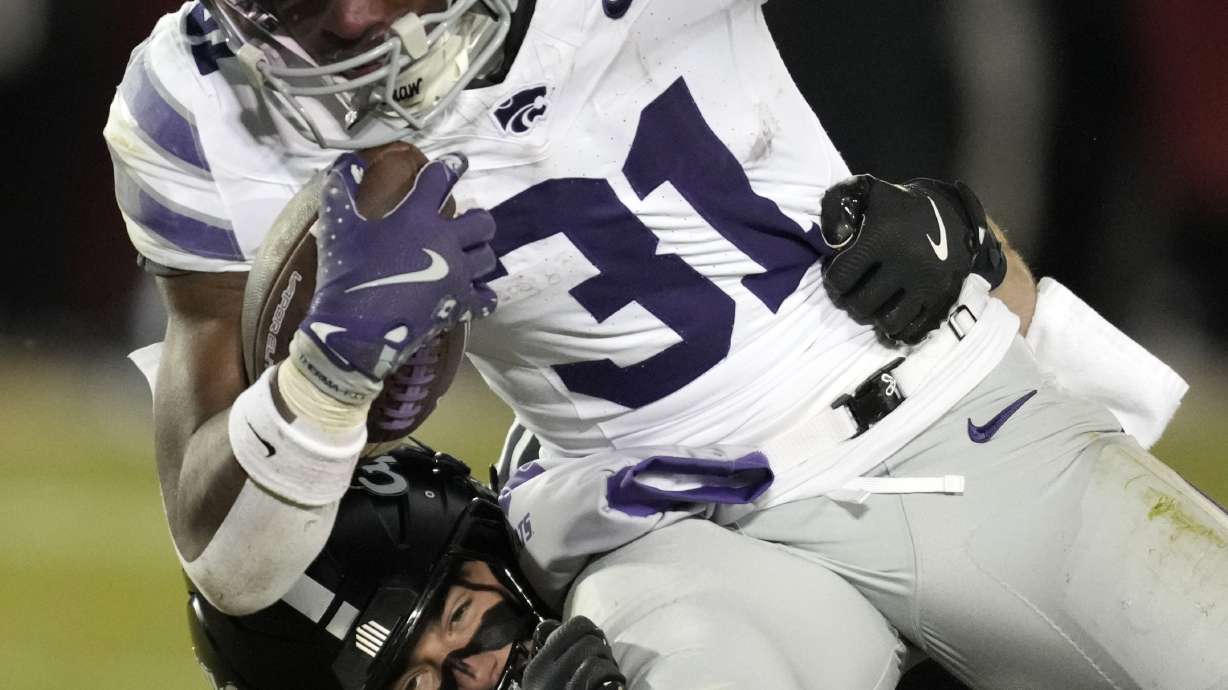 Kansas State running back DJ Giddens (31) is tackled by Iowa State defensive back Beau Freyler (17) during the second half of an NCAA college football game, Saturday, Nov. 30, 2024, in Ames, Iowa.