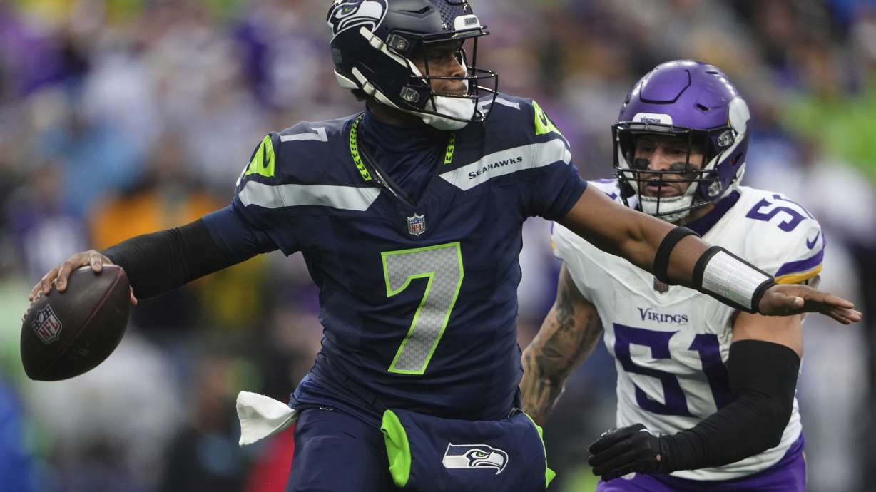 Seattle Seahawks quarterback Geno Smith (7) looks to pass while pressured by Minnesota Vikings linebacker Blake Cashman (51) during the second half of an NFL football game, Sunday, Dec. 22, 2024, in Seattle.