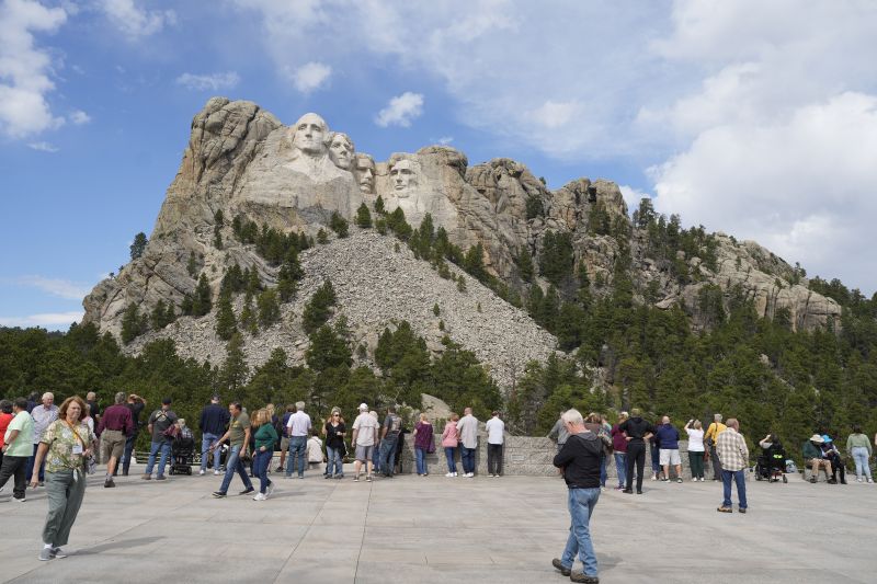 Visitors take in the massive sculpture carved into Mount Rushmore at the Mount Rushmore National Memorial Sept. 21, 2023, near Keystone, S.D.