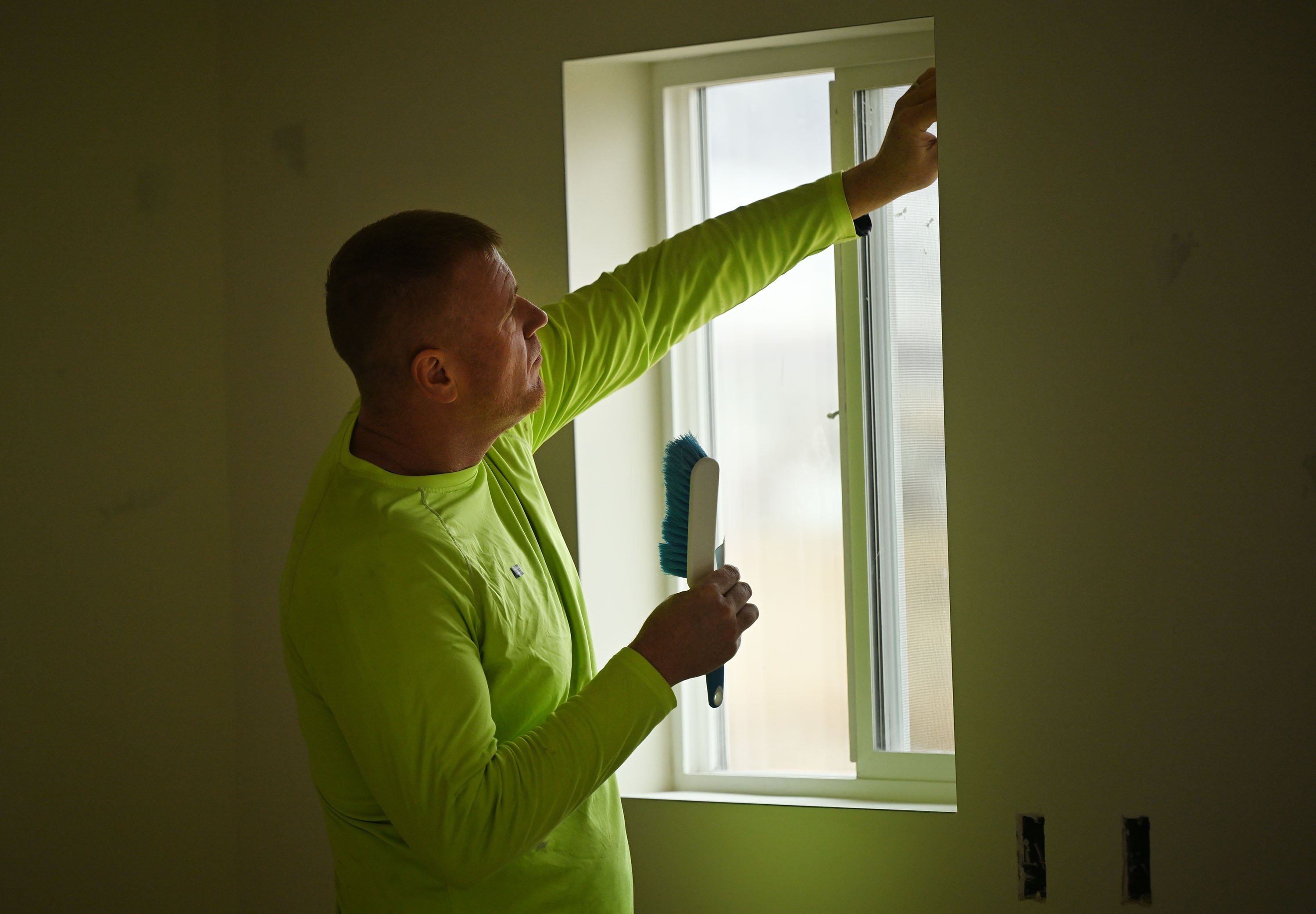 Elijah Rich works in a home as new buyers take part in Self-Help Homes, which completes affordable housing projects by facilitating loans and providing training so people can build their own houses, in Salem on Dec. 14.