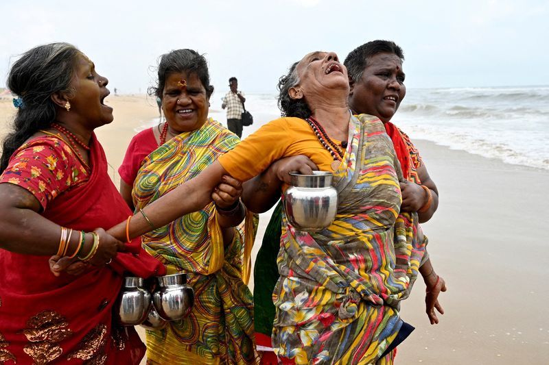 A woman is consoled as she cries during a prayer ceremony for the victims of the 2004 Indian Ocean Tsunami on the 20th anniversary of the disaster, at Pattinapakkam beach in Chennai, India, Thursday.