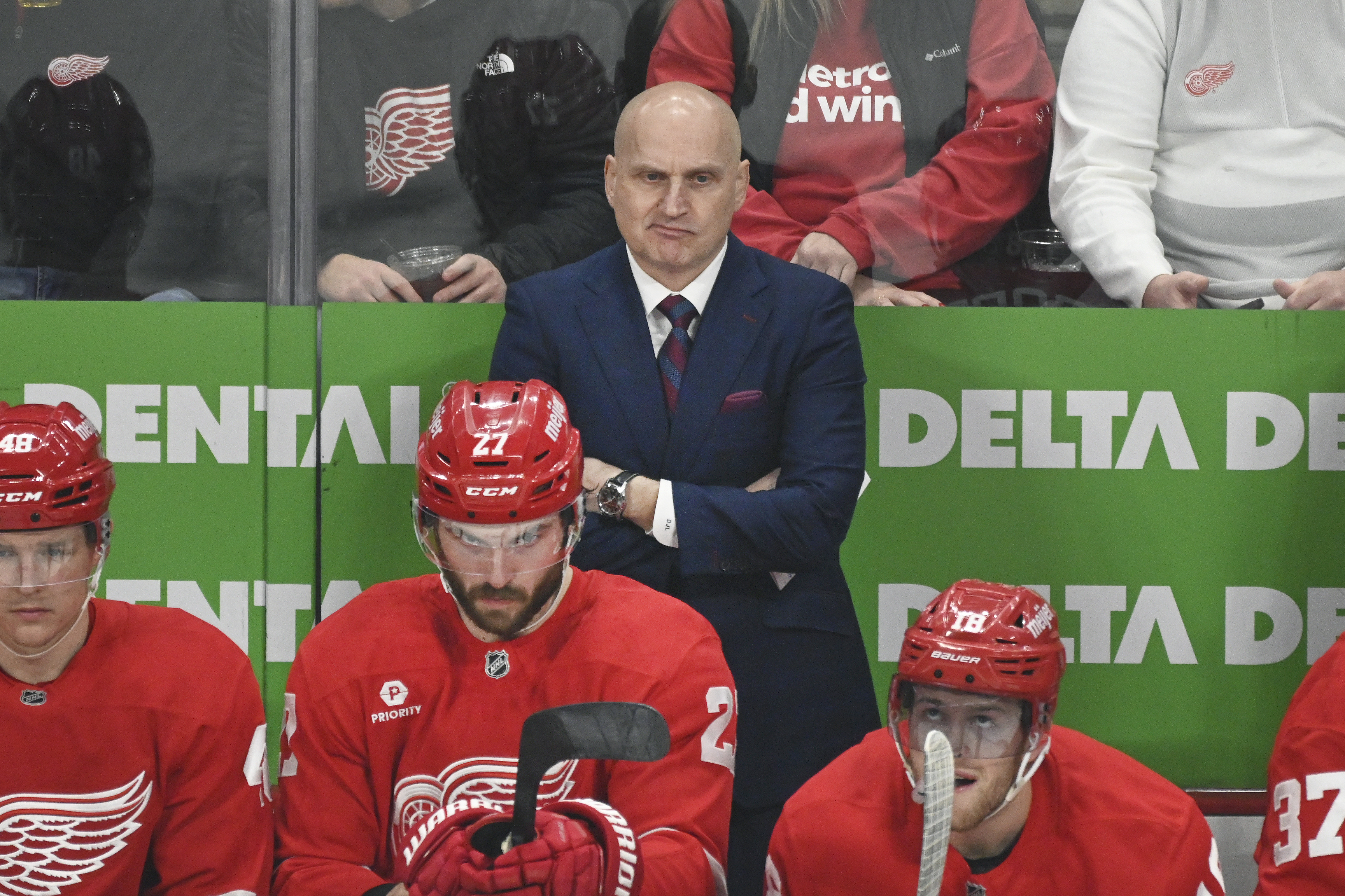 Detroit Red Wings head coach Derek Lalonde, standing, watches during the first period of an NHL hockey game against the St. Louis Blues, Monday, Dec. 23, 2024, in Detroit.