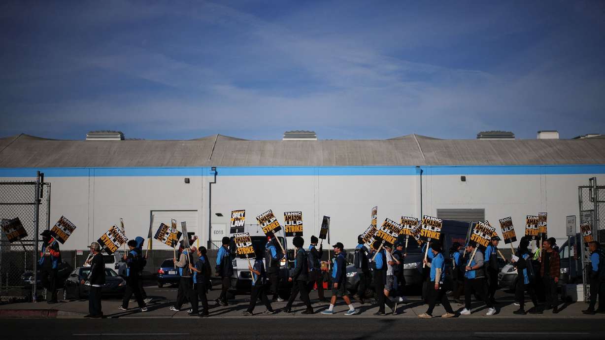 Striking workers picket outside an Amazon warehouse in City of Industry, Calif., on Dec. 19. Thousands of Amazon workers have ended their days-long strike against the company.