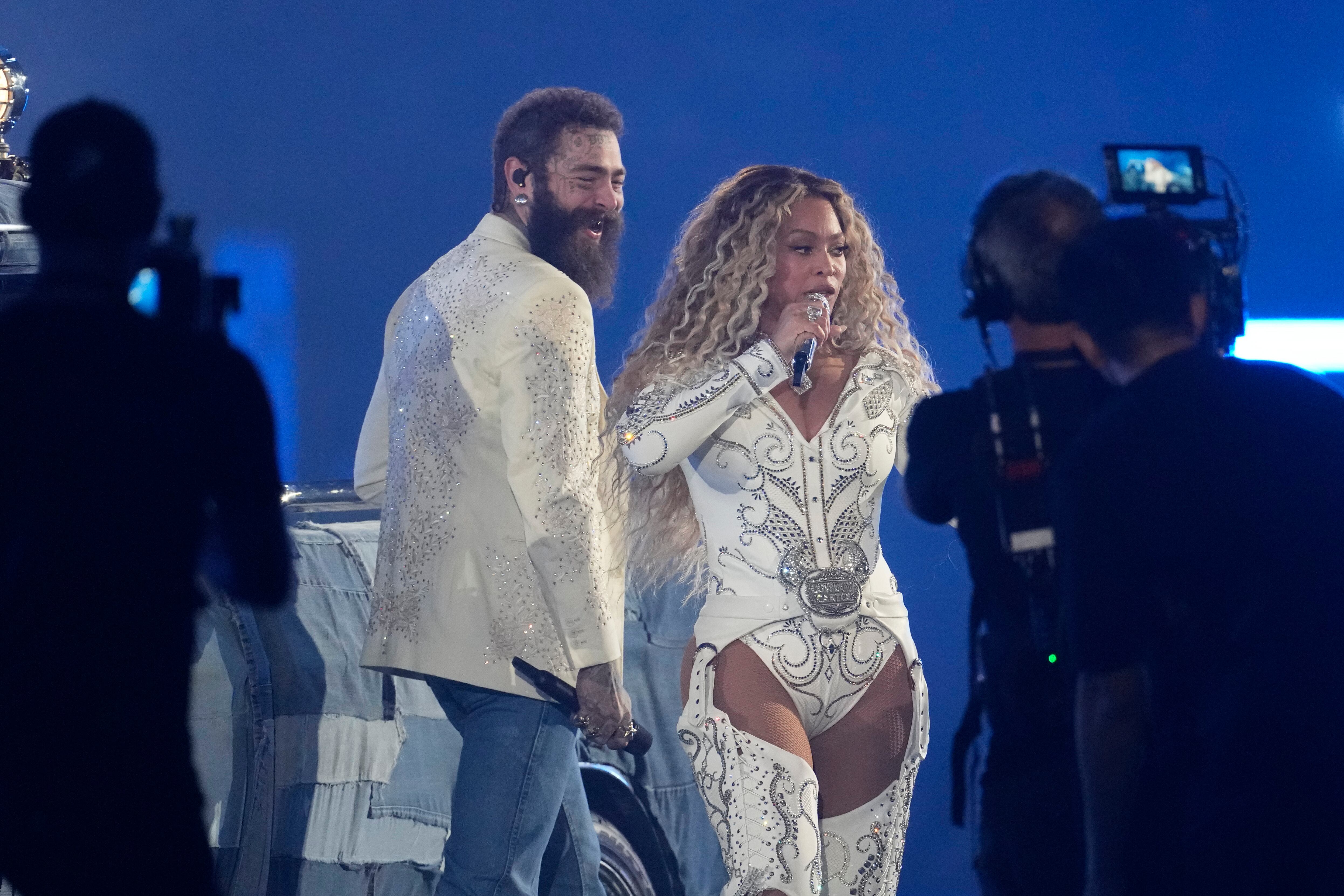 Post Malone, left, joins Beyoncé during a halftime performance in an NFL football game between the Baltimore Ravens and Houston Texans, Wednesday, in Houston.