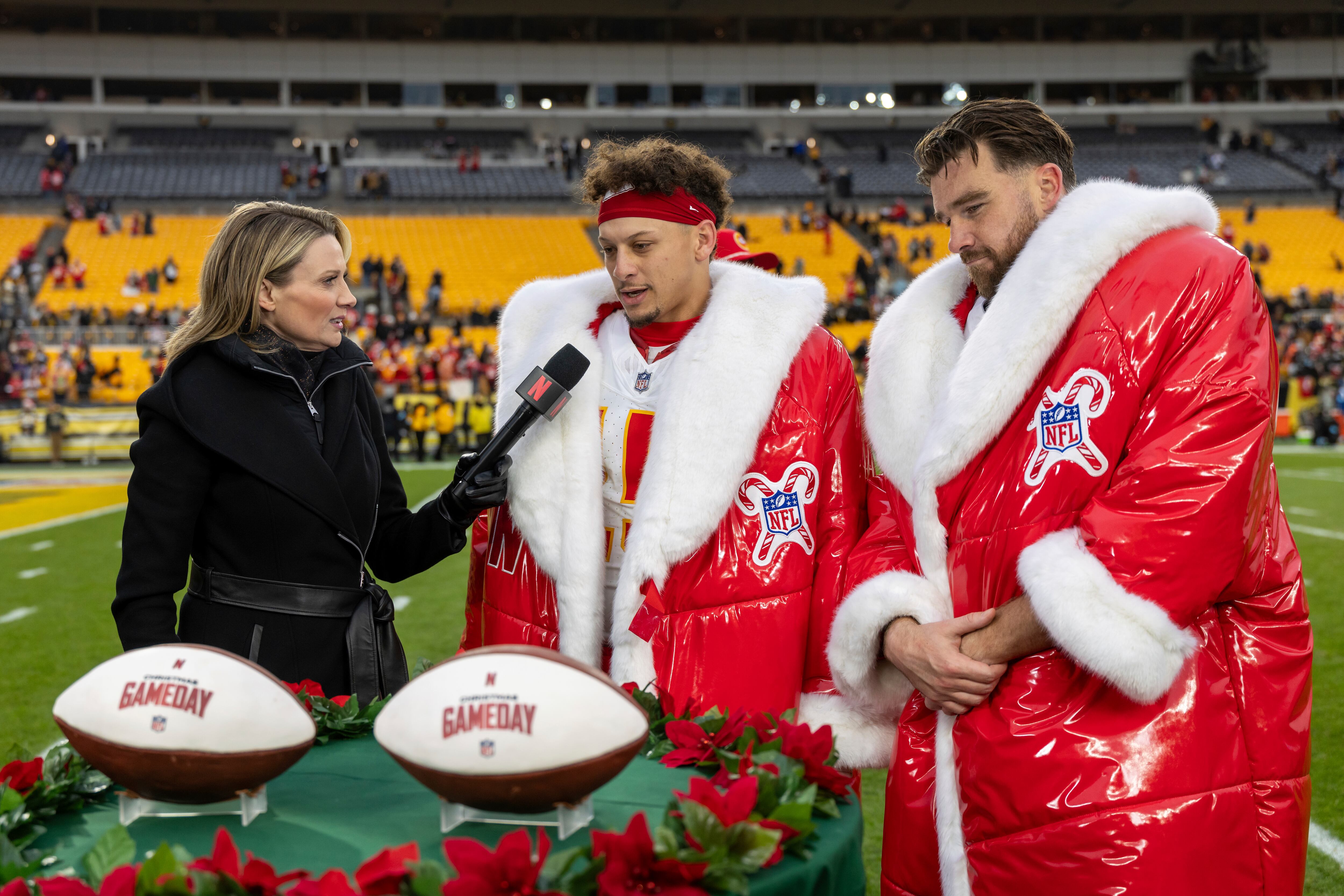 Netflix reporter Stacey Dales interviews Kansas City Chiefs quarterback Patrick Mahomes (15) and tight end Travis Kelce (87) after an NFL football game, Wednesday, in Pittsburgh.