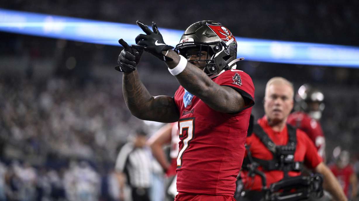 Tampa Bay Buccaneers running back Bucky Irving celebrates after rushing for a touchdown against th eDallas Cowboys in the first half of an NFL football game in Arlington, Texas, Sunday, Dec. 22, 2024.