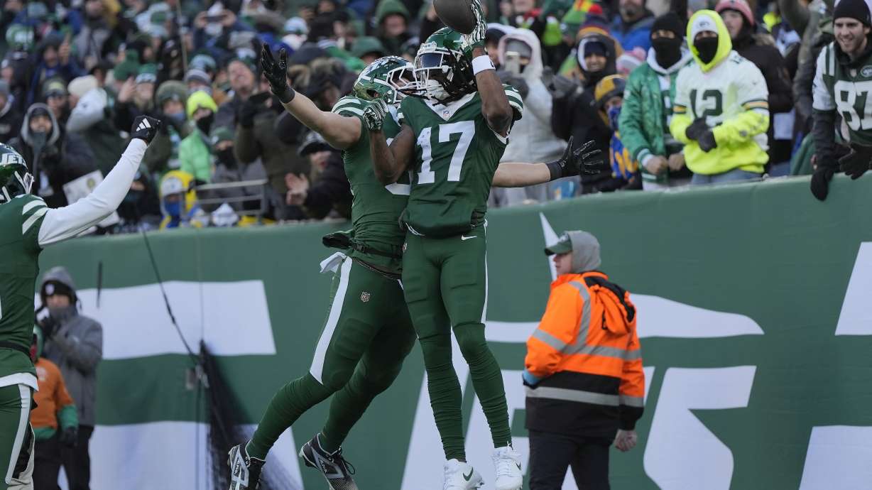 New York Jets wide receiver Davante Adams (17) is congratulated by tight end Jeremy Ruckert after scoring against the Los Angeles Rams during the first half of an NFL football game in East Rutherford, N.J., Sunday, Dec. 22, 2024.