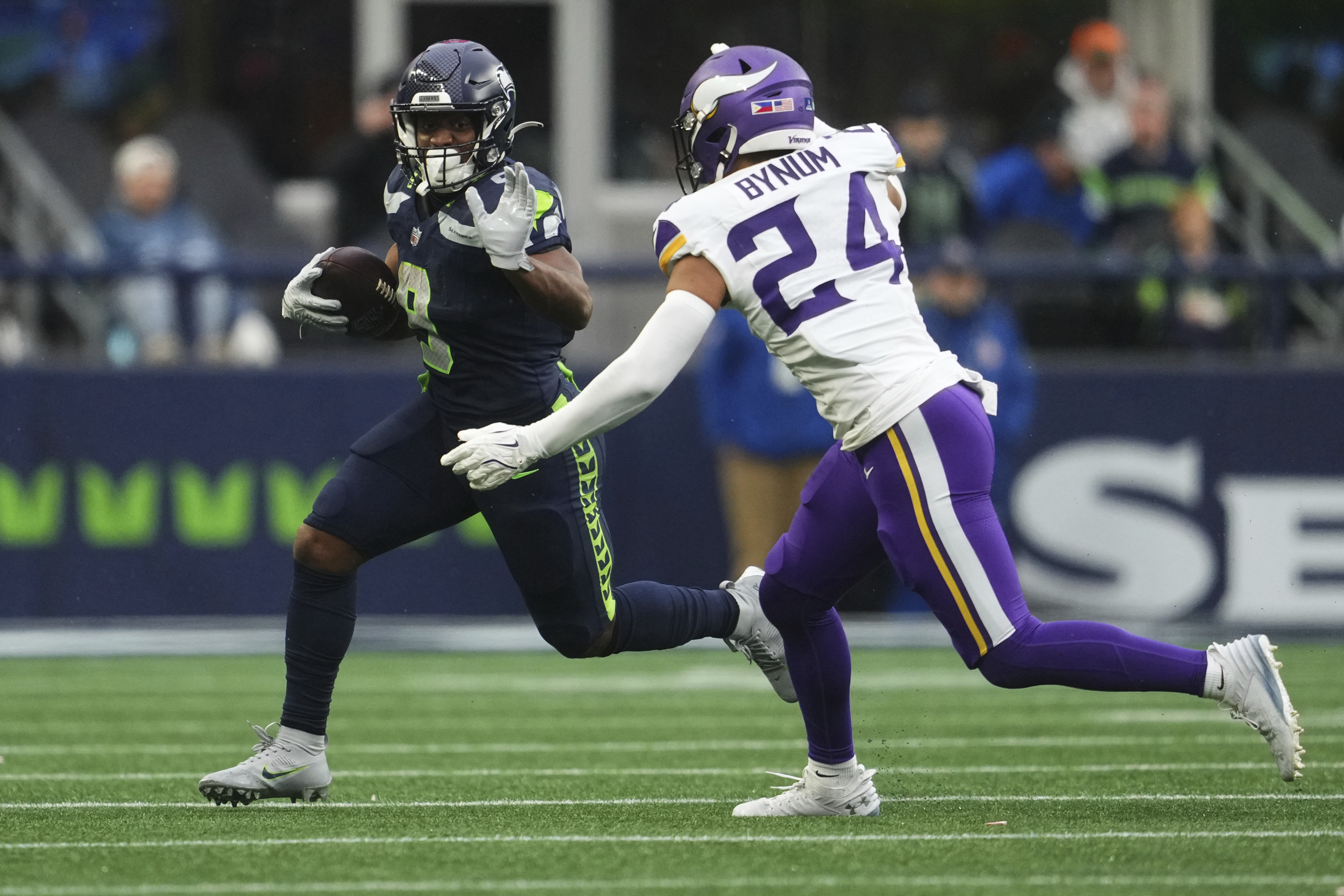 Seattle Seahawks running back Kenneth Walker III (9) runs with the football as Minnesota Vikings safety Camryn Bynum (24) tries to tackle during the second half of an NFL football game, Sunday, Dec. 22, 2024, in Seattle.