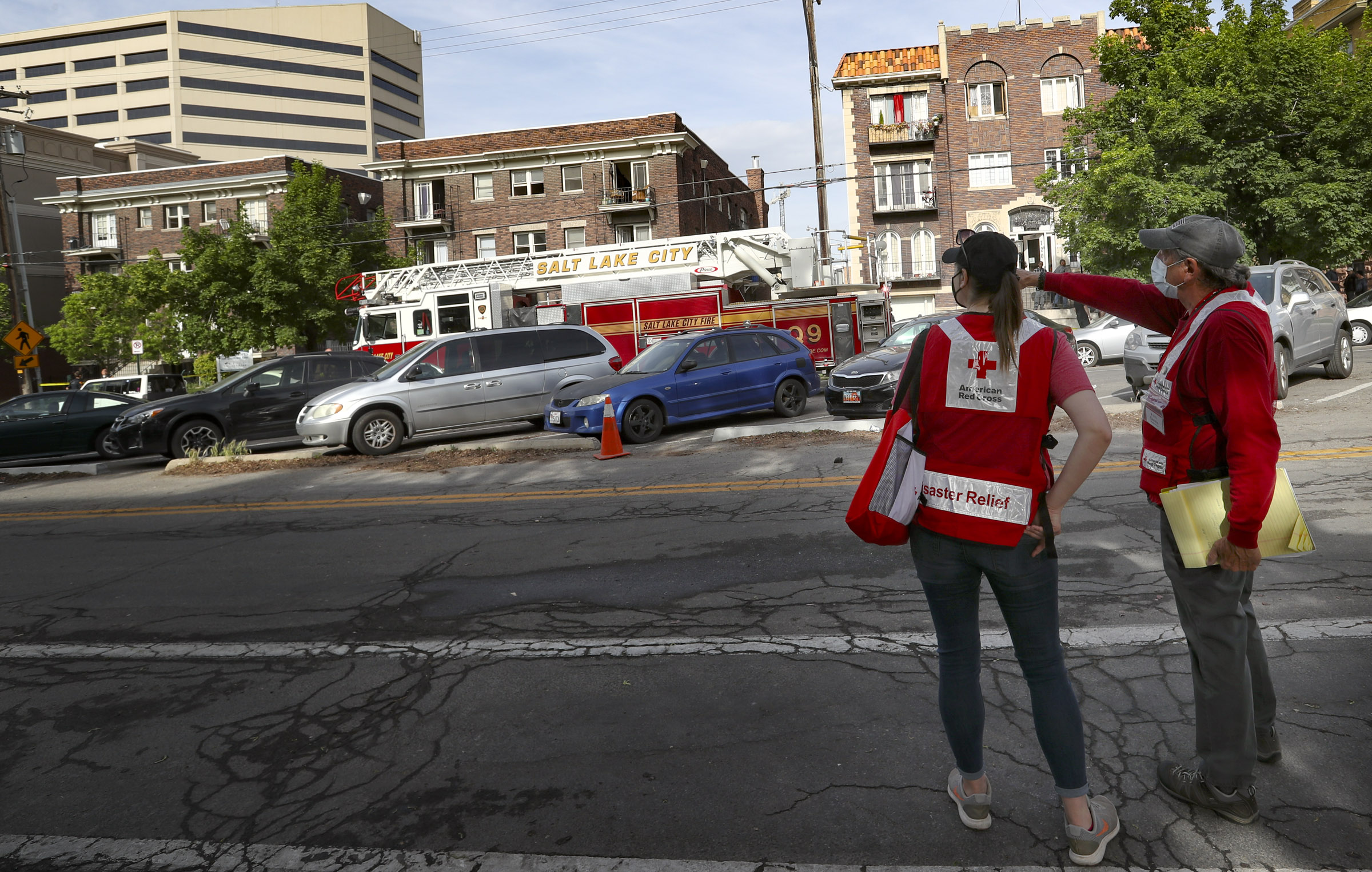 Salt Lake City firefighters and American Red Cross representatives are pictured at the Embassy Apartments at 120 S. 300 East in Salt Lake City after a fire, May 12, 2020.