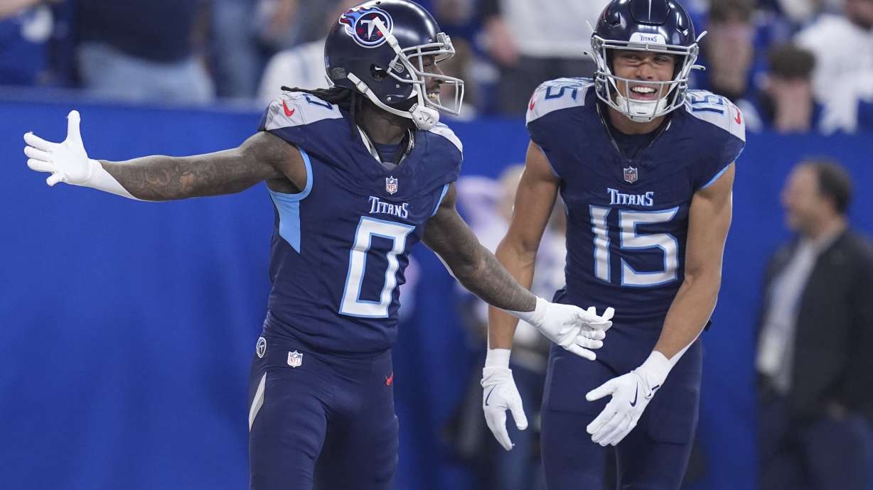 Tennessee Titans wide receiver Calvin Ridley (0) celebrates his touchdown with teammate Nick Westbrook-Ikhine (15) during the first half of an NFL football game against the Indianapolis Colts, Sunday, Dec. 22, 2024, in Indianapolis.