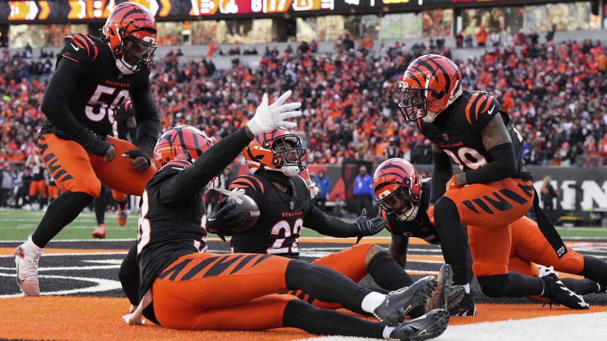 Cincinnati Bengals safety Geno Stone (22) celebrates with teammates after an interception during the second half of an NFL football game against the Cleveland Browns, Sunday, Dec. 22, 2024, in Cincinnati.