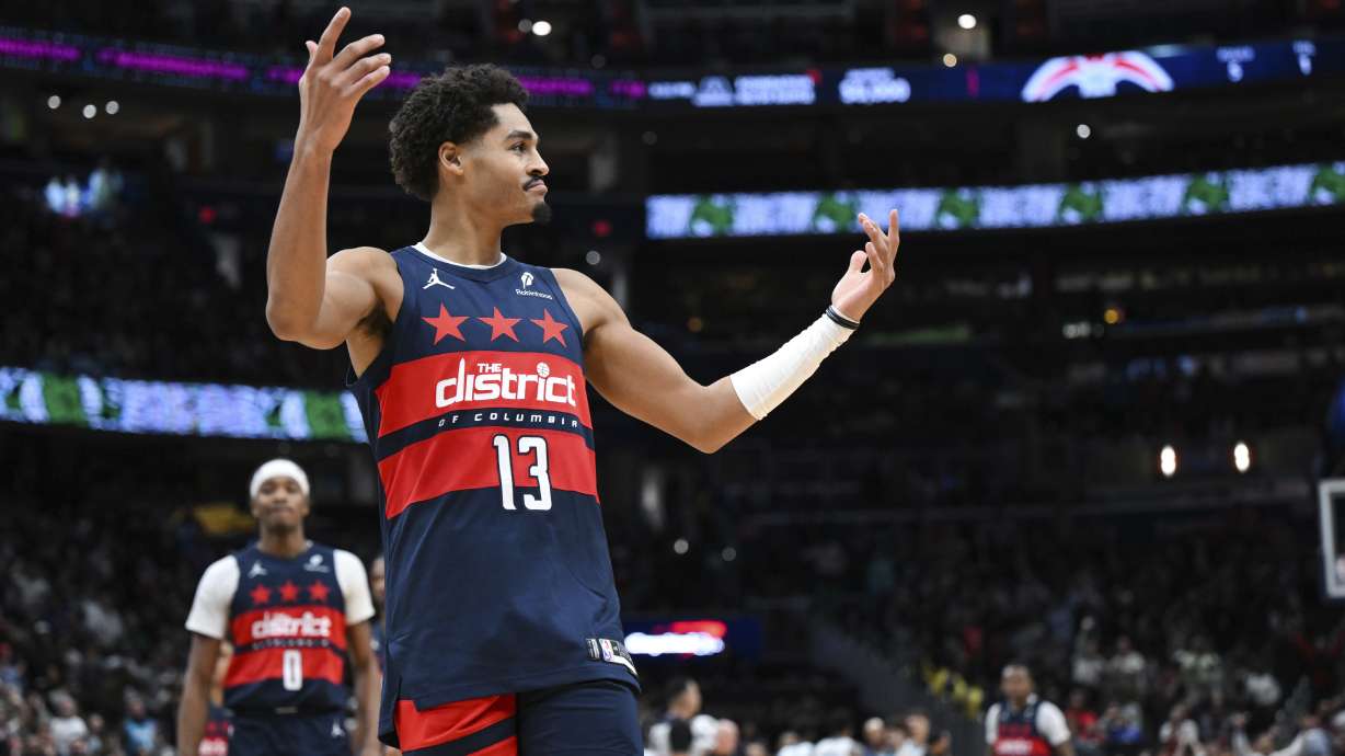 Washington Wizards guard Jordan Poole (13) reacts after making the winning 3-point basket during the second half of an NBA basketball game against the Charlotte Hornets, Thursday, Dec. 26, 2024, in Washington.