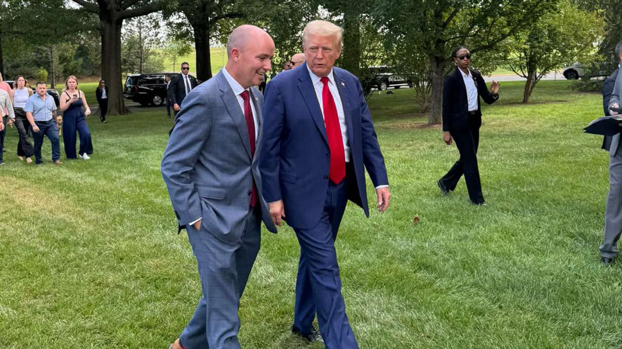 Gov. Spencer Cox walks with President-elect Donald Trump during a press event at Arlington National Cemetery, Aug. 26, in Arlington, Va.