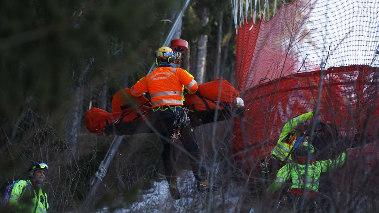 Medical staff are carrying France's Cyprien Sarrazin after crashing into protections net during an alpine ski, men's World Cup downhill training, in Bormio, Italy, Friday, Dec. 27, 2024.