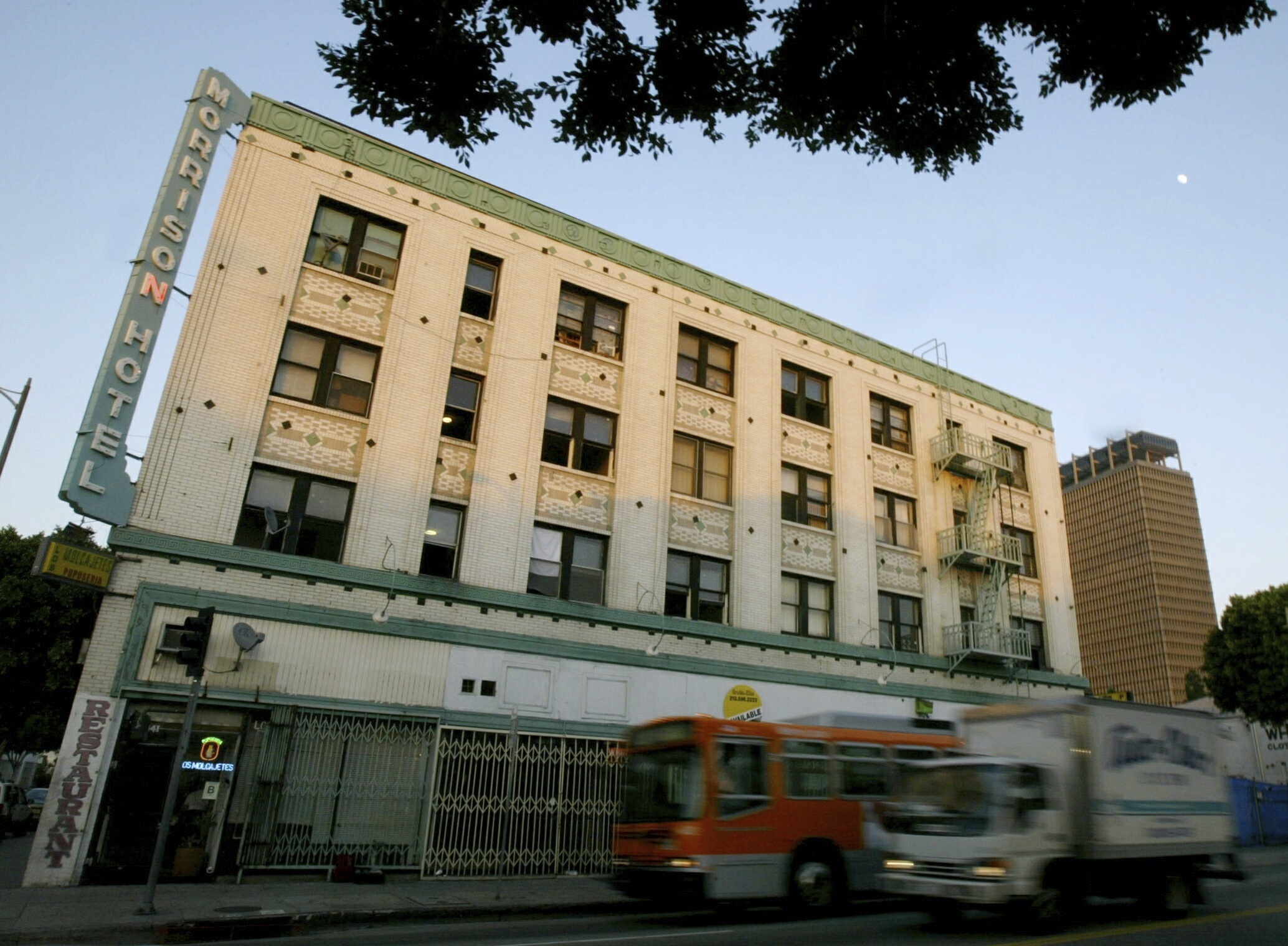 Vehicles drive past the Morrison Hotel in Los Angeles. The iconic hotel, recently used as a training ground for firefighters, was involved in a fire Thursday.