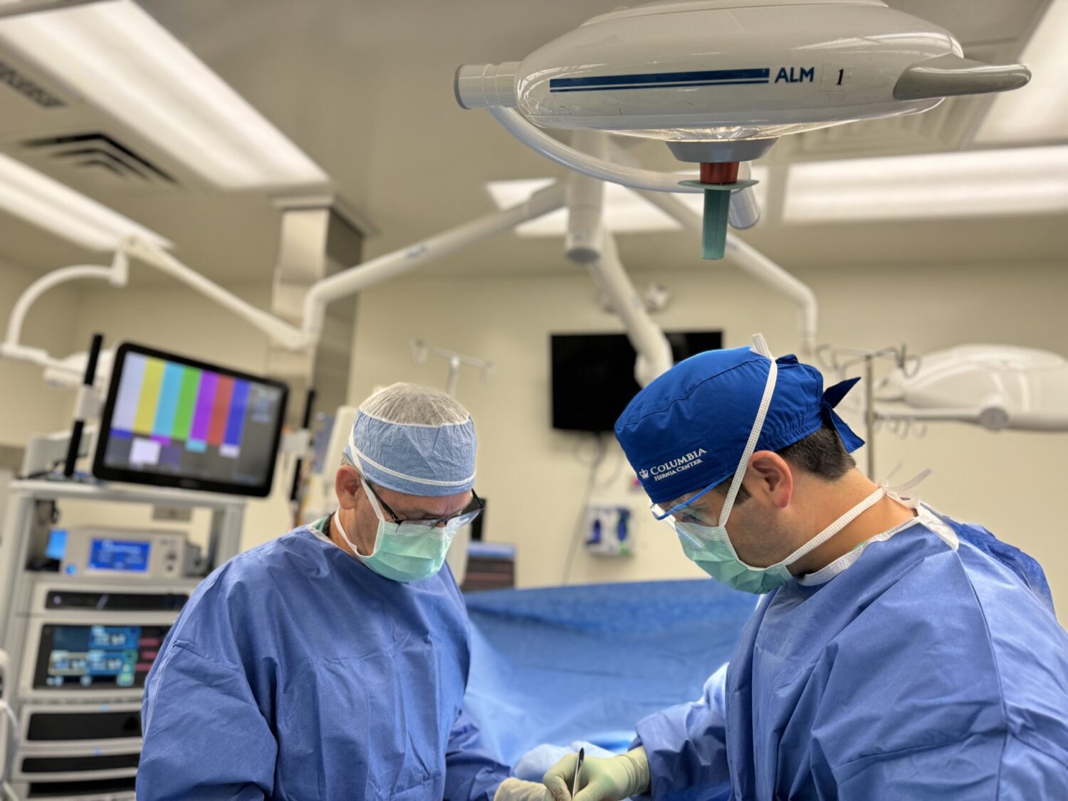 David Morrell and Glen Morrel performing surgery together. They are two of three surgeons in their family.