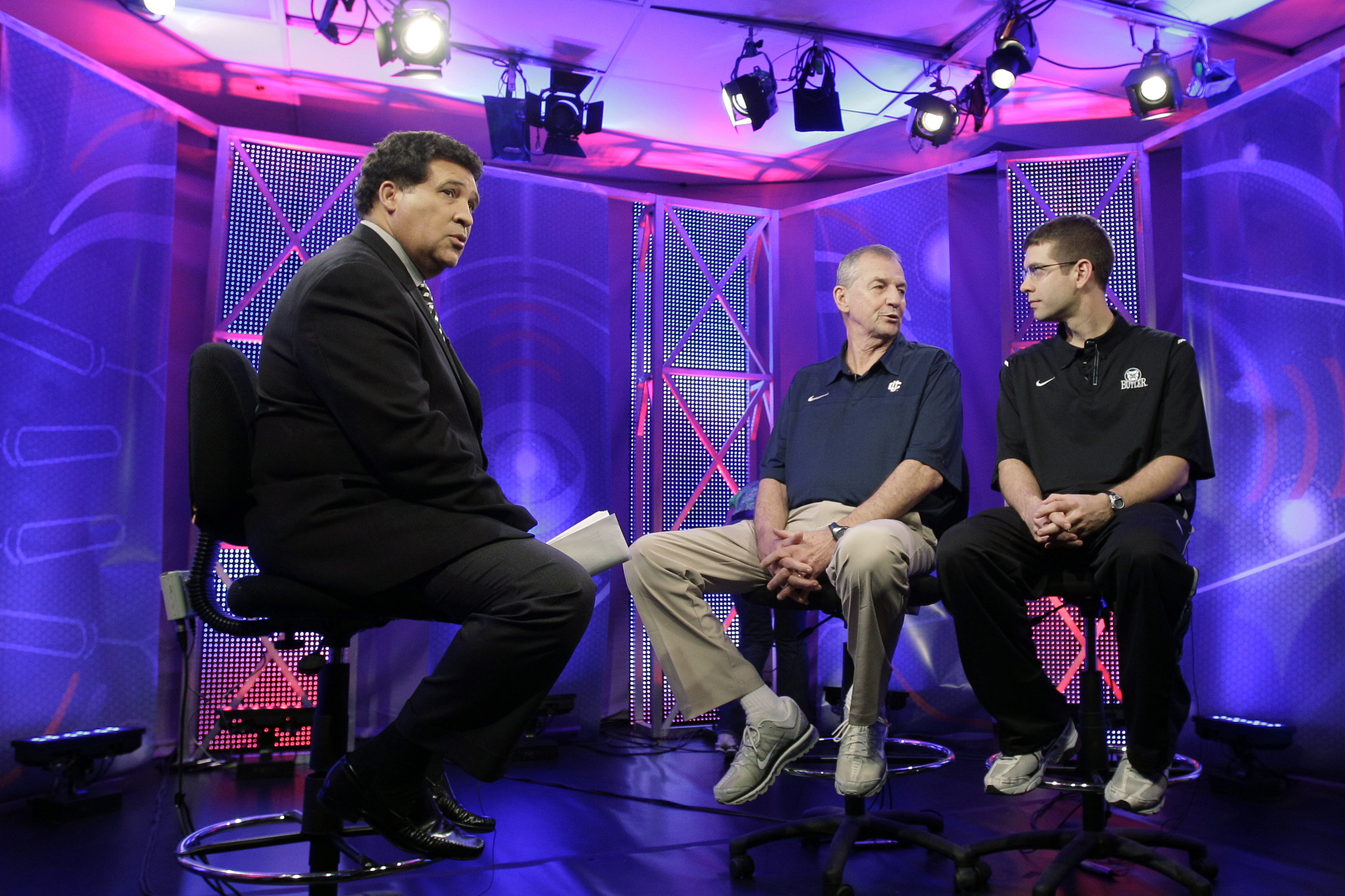 Greg Gumbel watches as Jim Calhoun talks to Brad Stevens prior to taping a television interview for the national championship game in Houston in 2011.