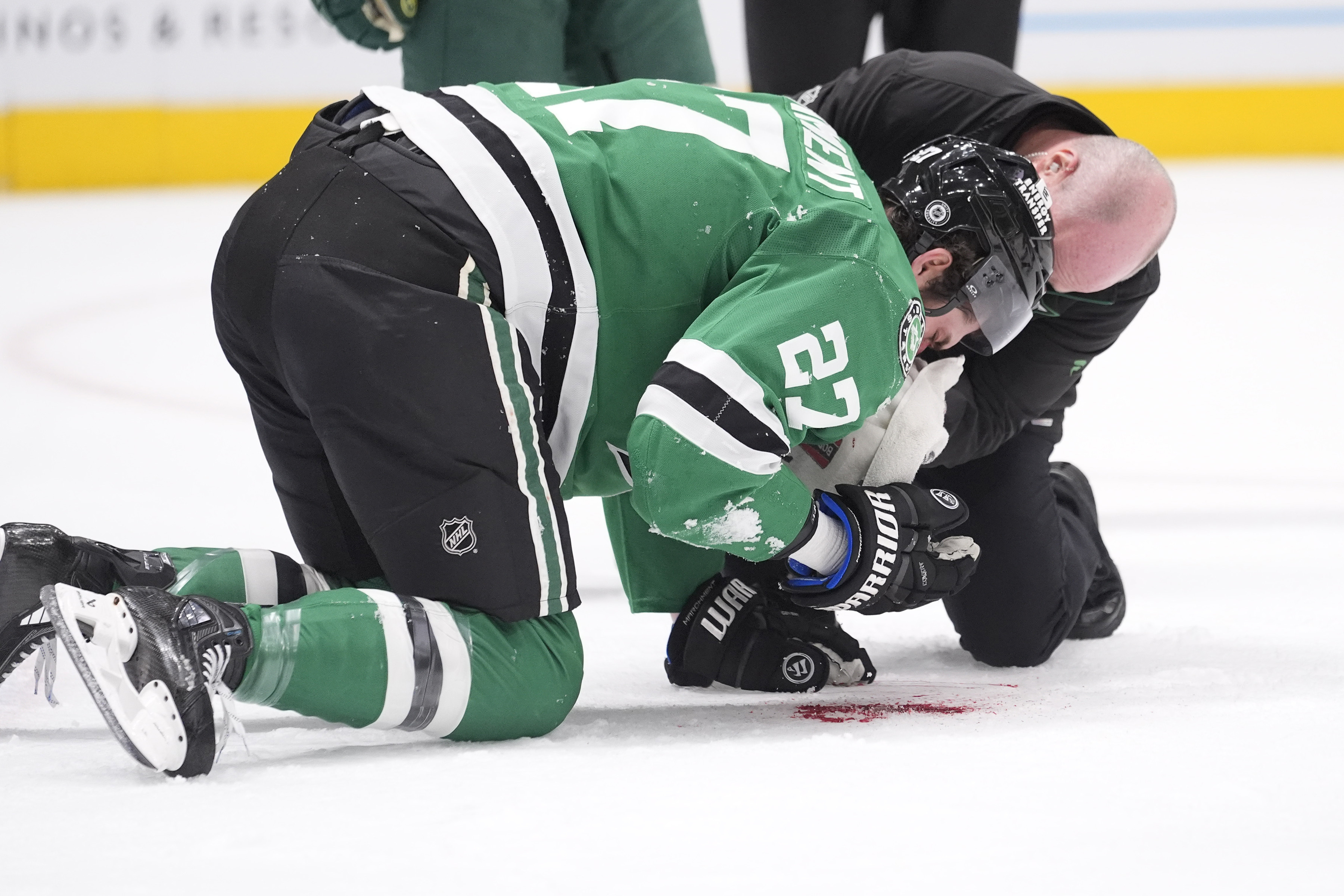 Dallas Stars left wing Mason Marchment (27) is tended to after he was hit by the puck during the first period of an NHL hockey game against the Minnesota Wild, Friday, Dec. 27, 2024, in Dallas. 