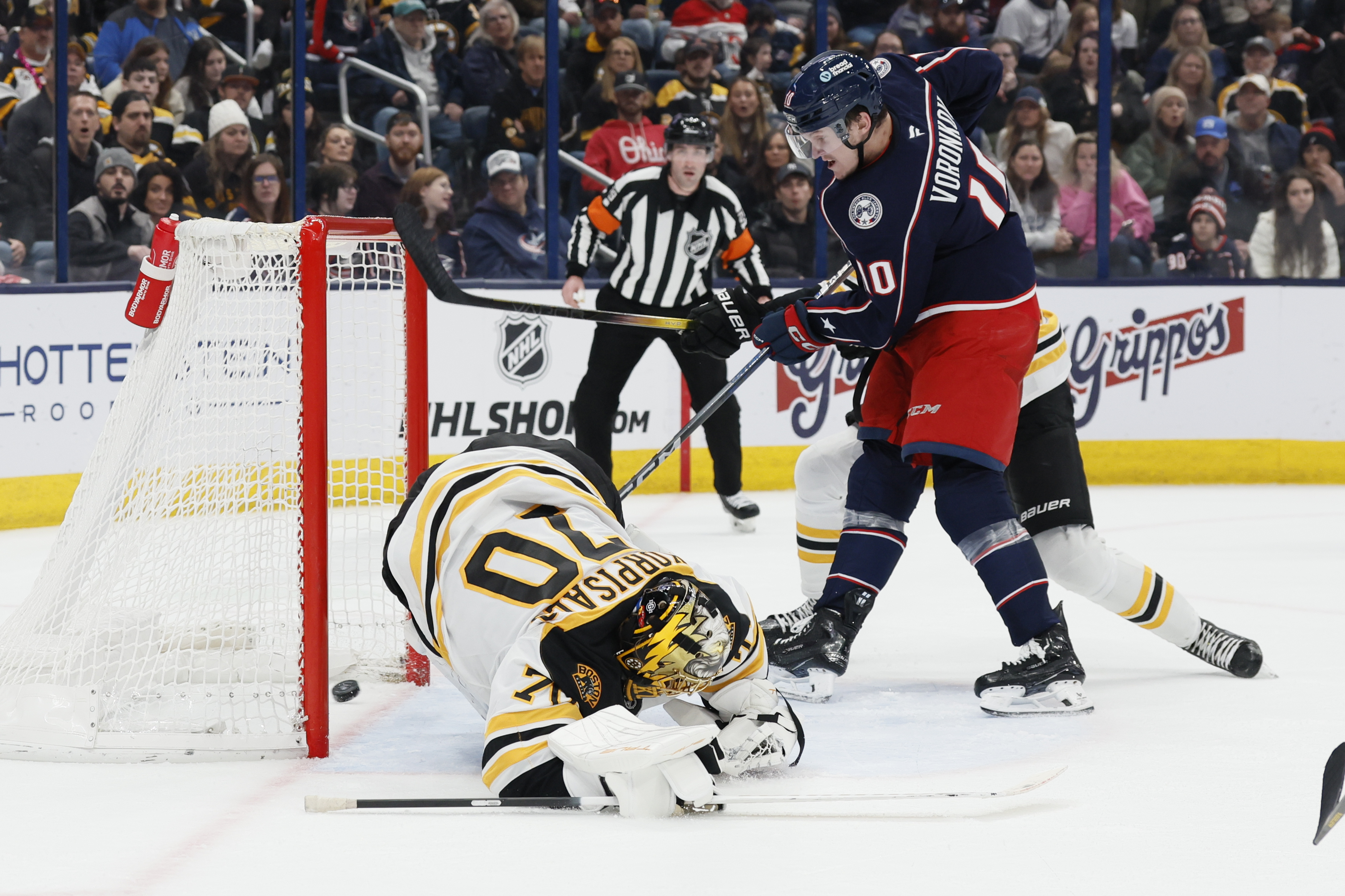 Columbus Blue Jackets' Dmitri Voronkov, right, scores against Boston Bruins' Joonas Korpisalo during the second period of an NHL hockey game Friday, Dec. 27, 2024, in Columbus, Ohio. 