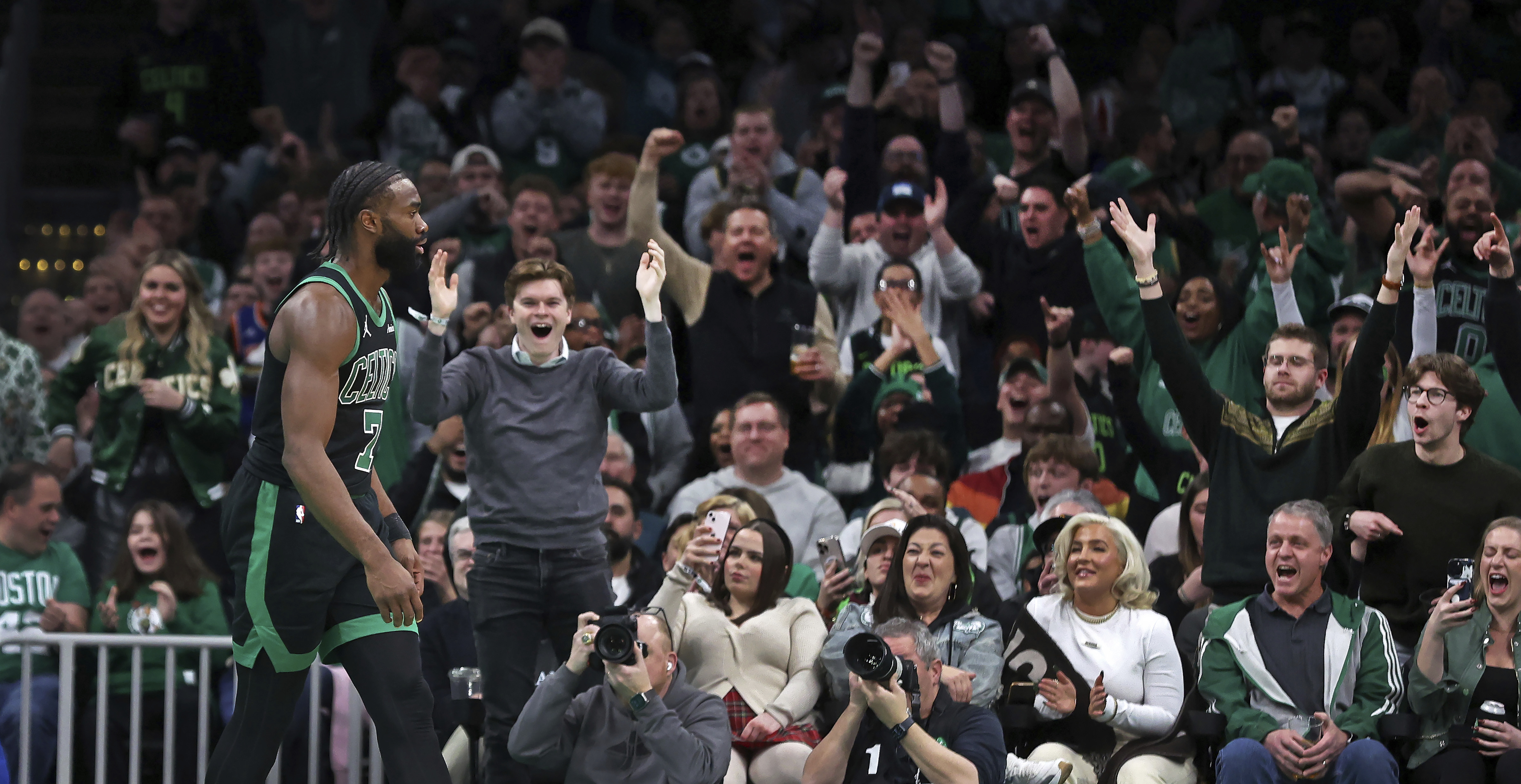 Fans react after Boston Celtics forward Jaylen Brown (7) slammed home two points during the second quarter of an NBA basketball game against the Indiana Pacers on Friday Dec. 27, 2024 in Boston.