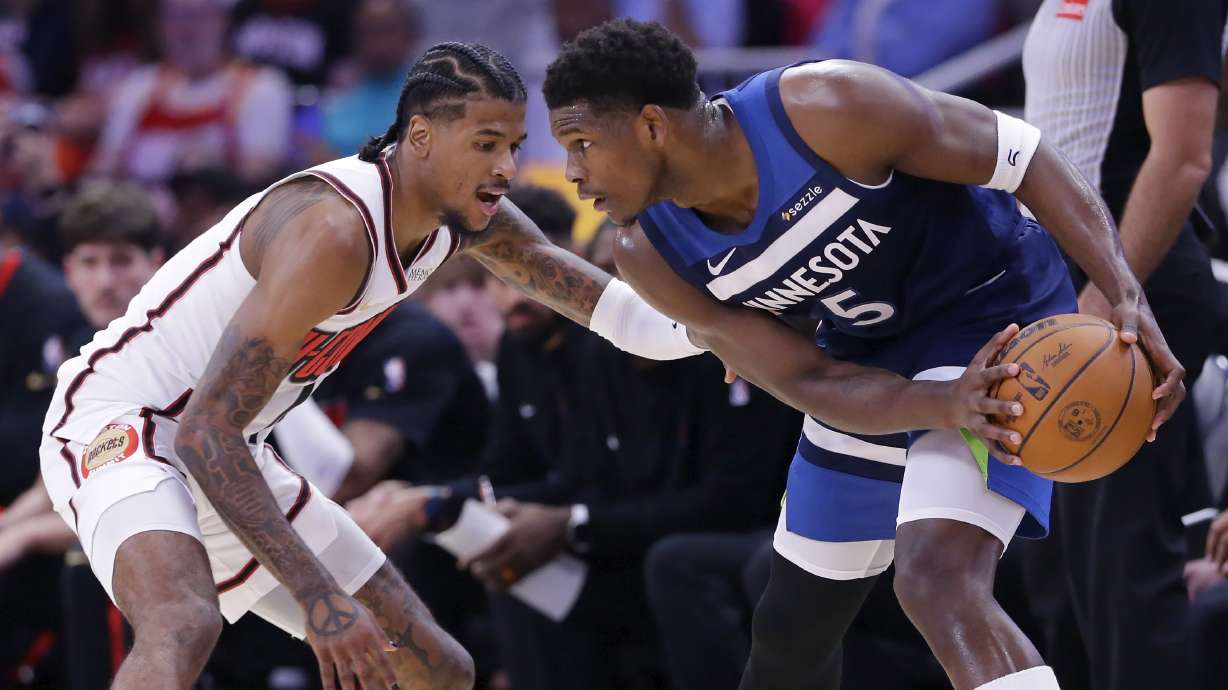 Minnesota Timberwolves guard Anthony Edwards (5) looks to drive around Houston Rockets guard Jalen Green, left, during the first half of an NBA basketball game Friday, Dec. 27, 2024, in Houston.