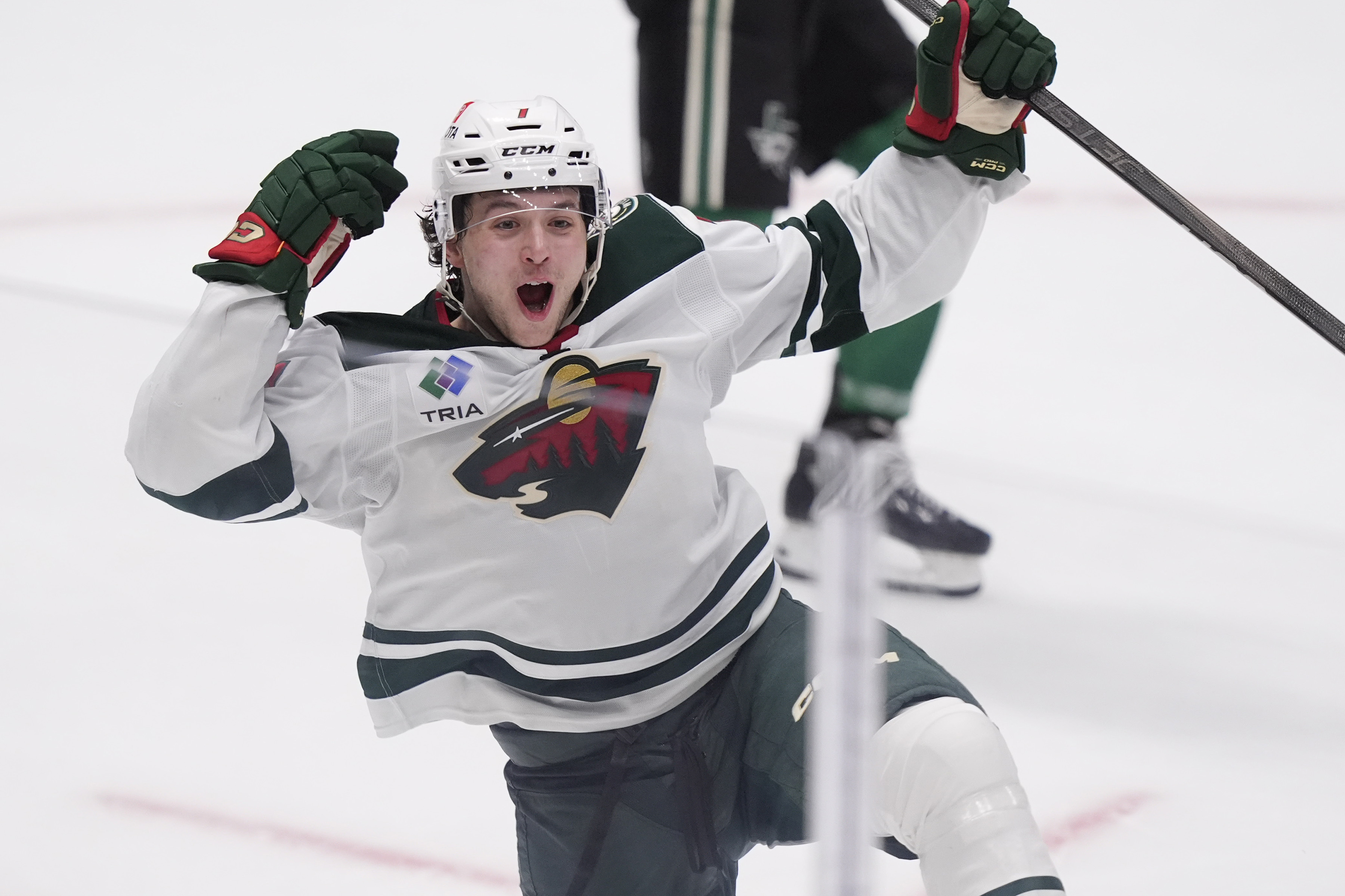 Minnesota Wild defenseman Brock Faber (7) celebrates scoring the winning goal in overtime of an NHL hockey game against the Dallas Stars Friday, Dec. 27, 2024, in Dallas. 