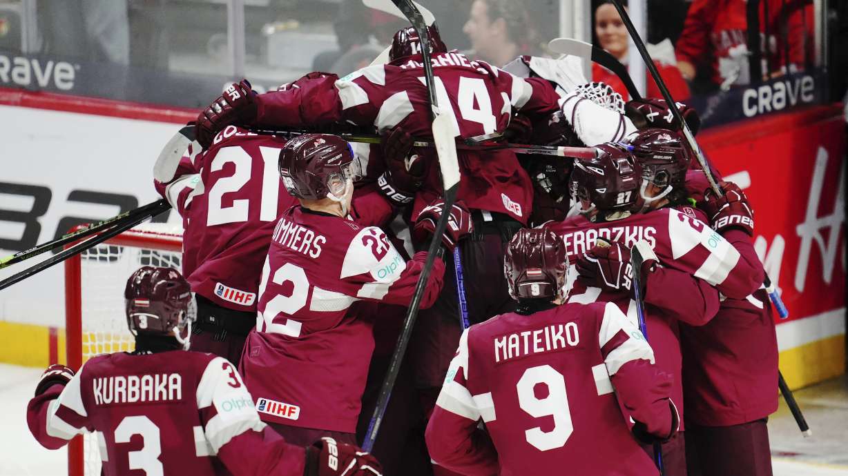 Latvia players celebrate after defeating Canada in shootout IIHF World Junior Hockey Championship preliminary round game action in Ottawa, Ontario, Friday, Dec. 27, 2024.