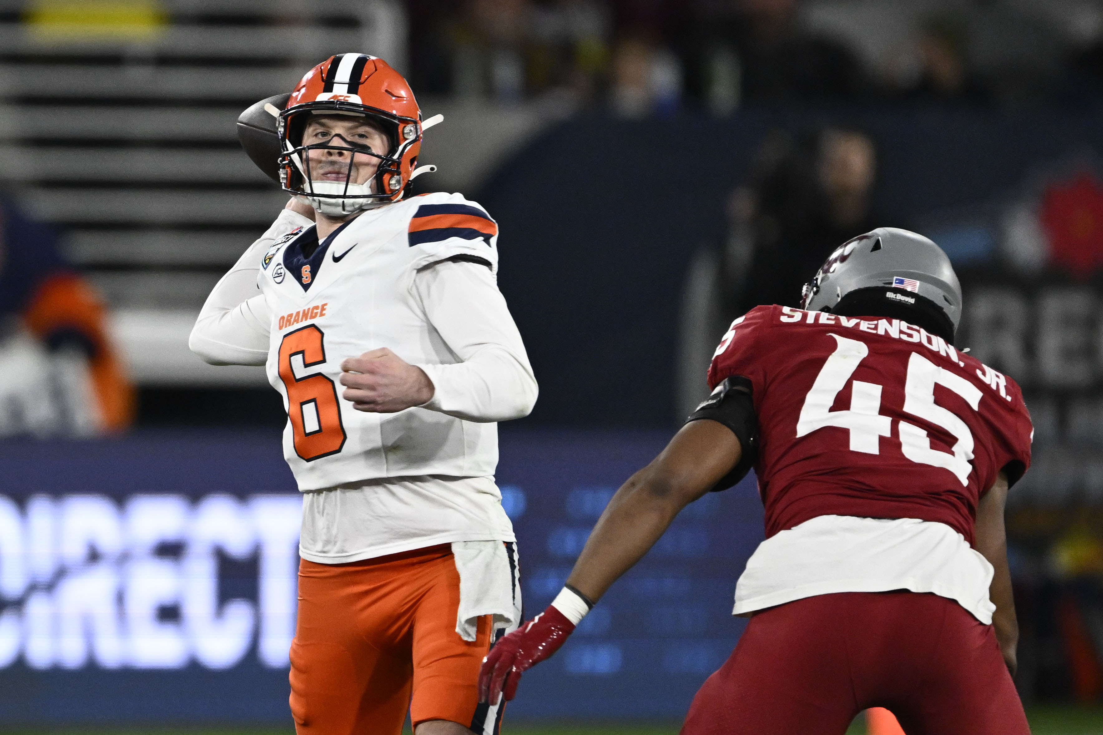 Syracuse quarterback Kyle McCord (6) passes under pressure from Washington State edge Raam Stevenson (45) during the first half of the Holiday Bowl NCAA college football game Friday, Dec. 27, 2024, in San Diego. 