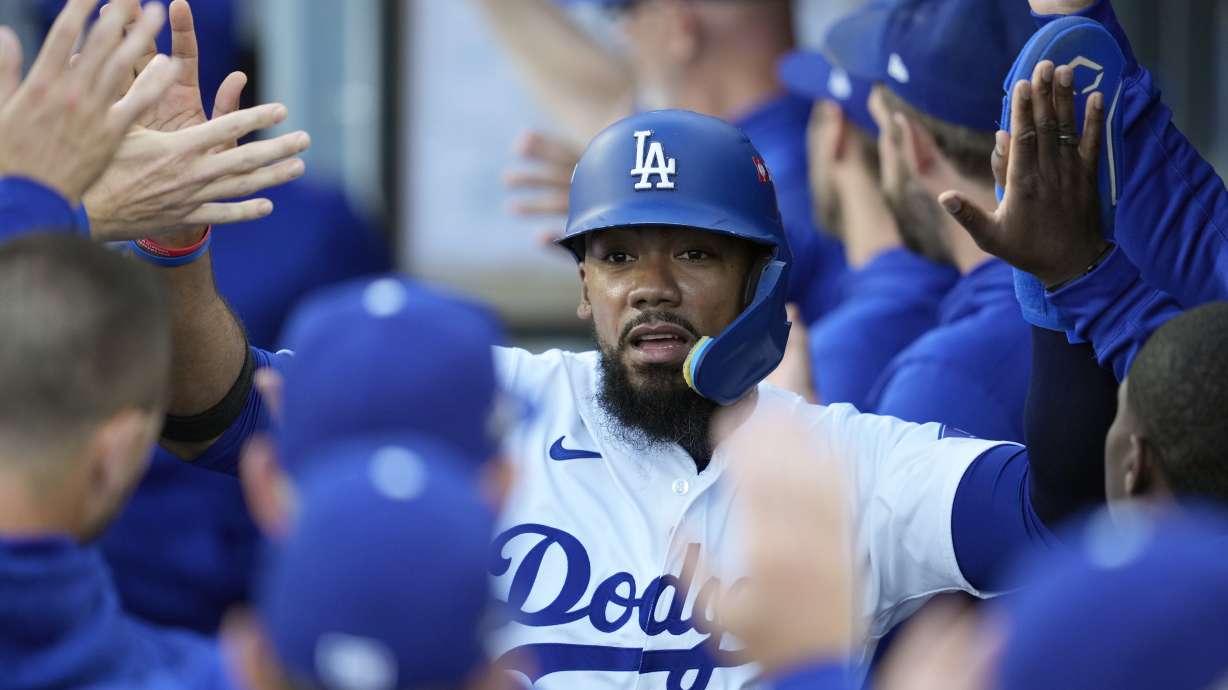 FILE - Los Angeles Dodgers' Teoscar Hernández is high-fived in the dugout after scoring on a sacrifice fly ball by Gavin Lux during the second inning in Game 2 of a baseball NL Division Series against the San Diego Padres, Sunday, Oct. 6, 2024, in Los Angeles.