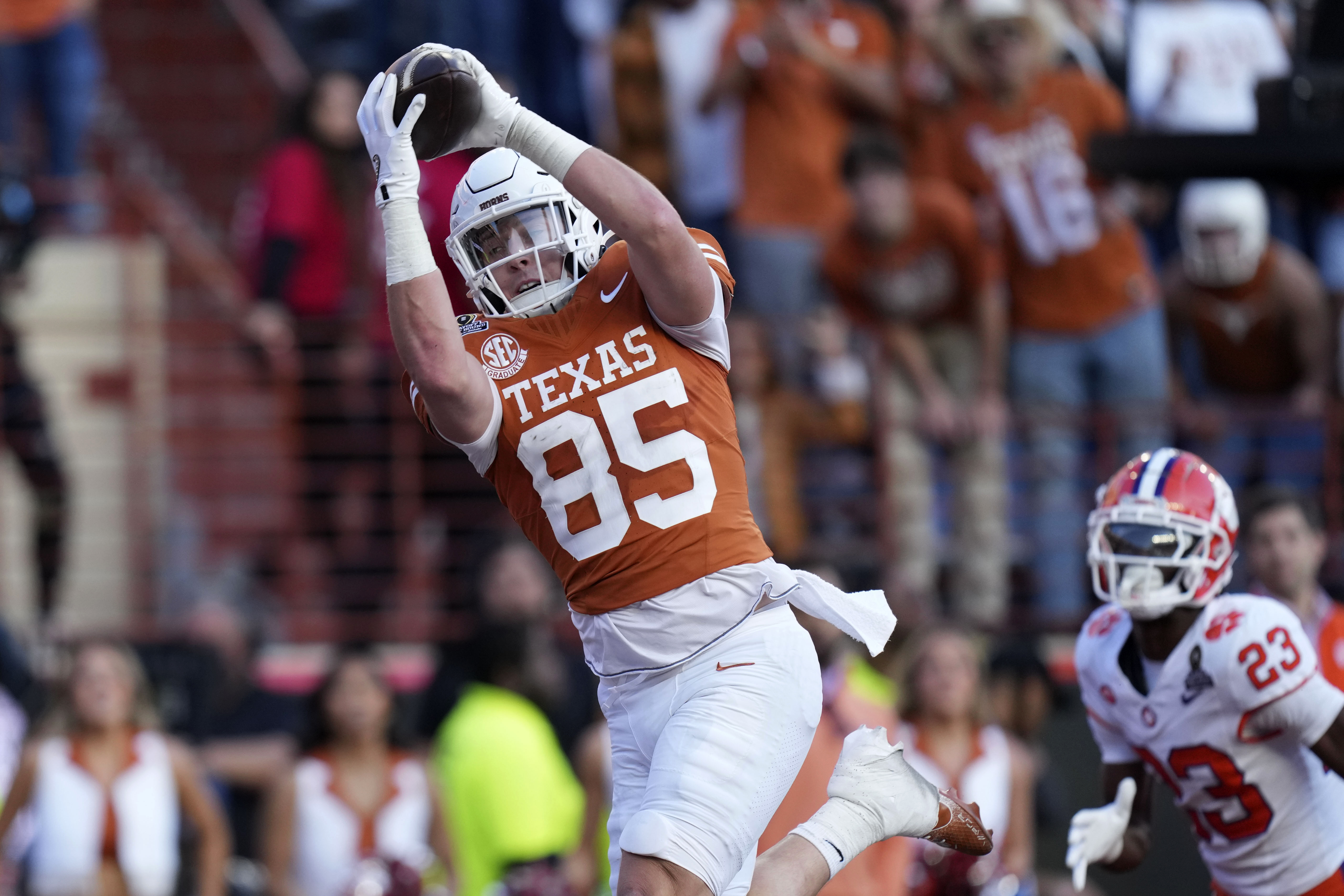 Texas tight end Gunnar Helm (85) catches a 19-yard touchdown pass ahead of Clemson cornerback Ashton Hampton (23) during the first half in the first round of the College Football Playoff, Saturday, Dec. 21, 2024, in Austin, Texas. 