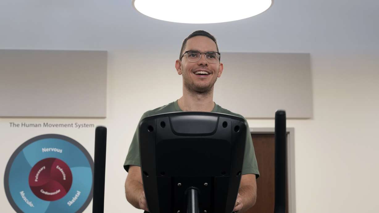 Jacob Bullard warms up on an elliptical machine while undergoing physical therapy at WashU, Monday, Dec. 16, 2024, in St. Louis.