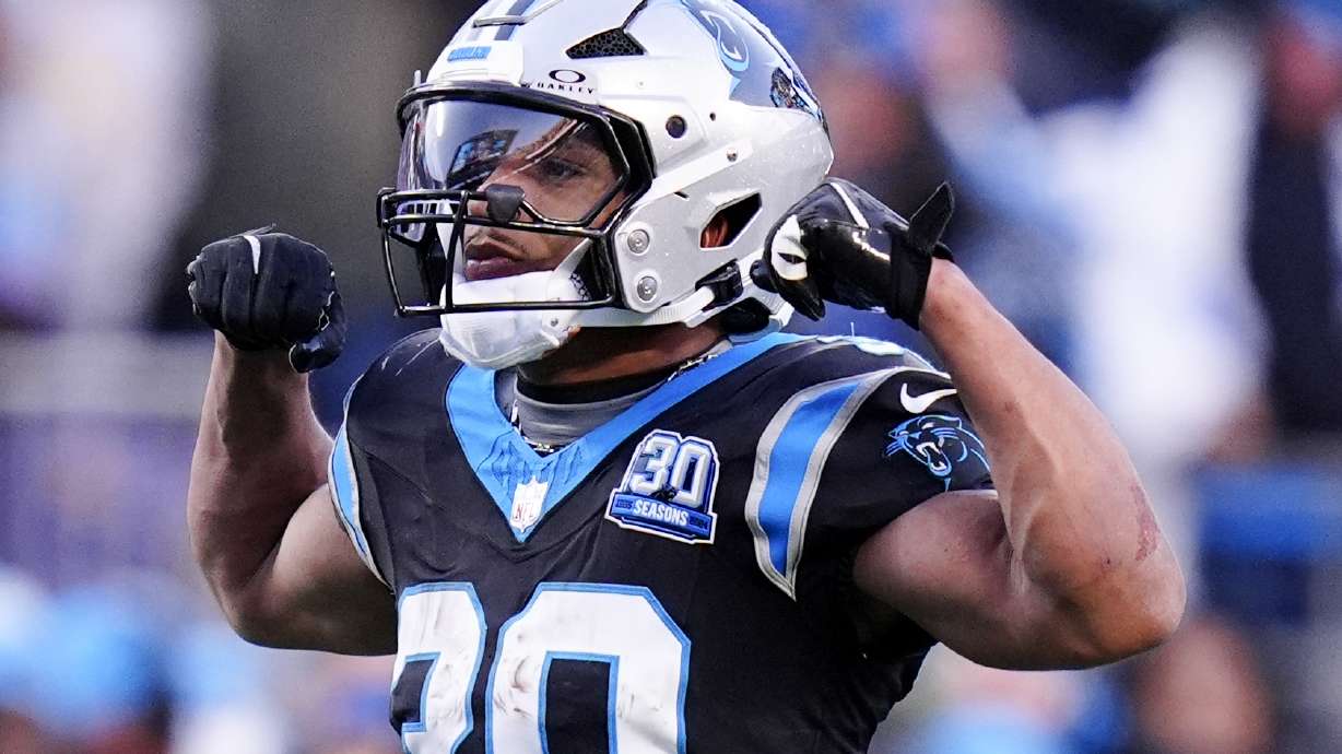 Carolina Panthers running back Chuba Hubbard celebrates after a long run against the Arizona Cardinals during overtime of an NFL football game, Sunday, Dec. 22, 2024, in Charlotte, N.C.