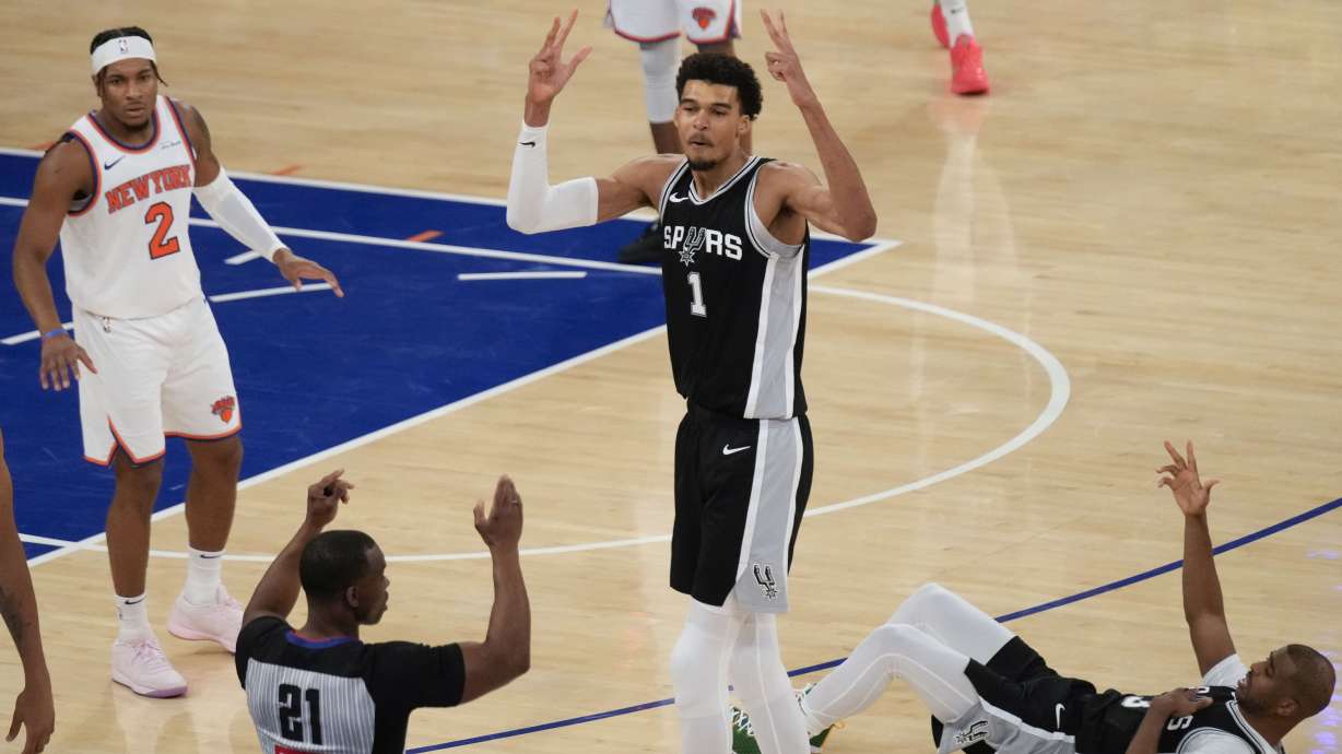 San Antonio Spurs' Victor Wembanyama (1), center, reacts as he sinks a three point basket during the second half of an NBA basketball game against the New York Knicks, Wednesday, Dec. 25, 2024, in New York. The basket was not counted after an officials review. The Knicks defeated the Spurs 117-114.