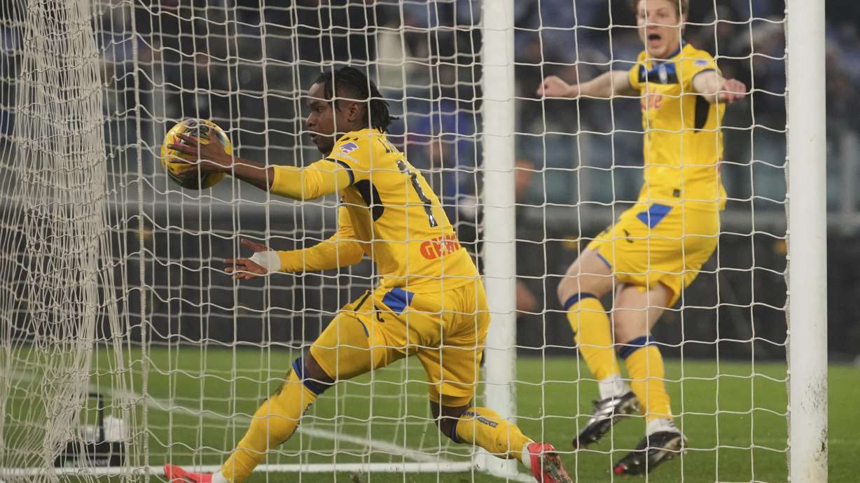 Atalanta's Ademola Lookman, left, celebrates after Atalanta's Marco Brescianini, right, scoring his side's opening goal during a Serie A soccer match between Lazio and Atalanta, at the Stadio Olimpico in Rome, Italy, Saturday, Dec. 28, 2024.