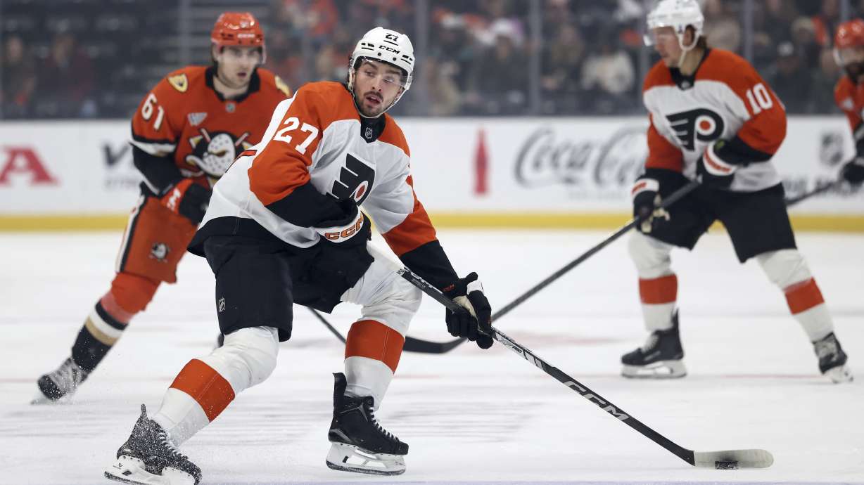Philadelphia Flyers left wing Noah Cates (27) controls the puck against the Anaheim Ducks during the first period of an NHL hockey game Saturday, Dec. 28, 2024, in Anaheim, Calif.