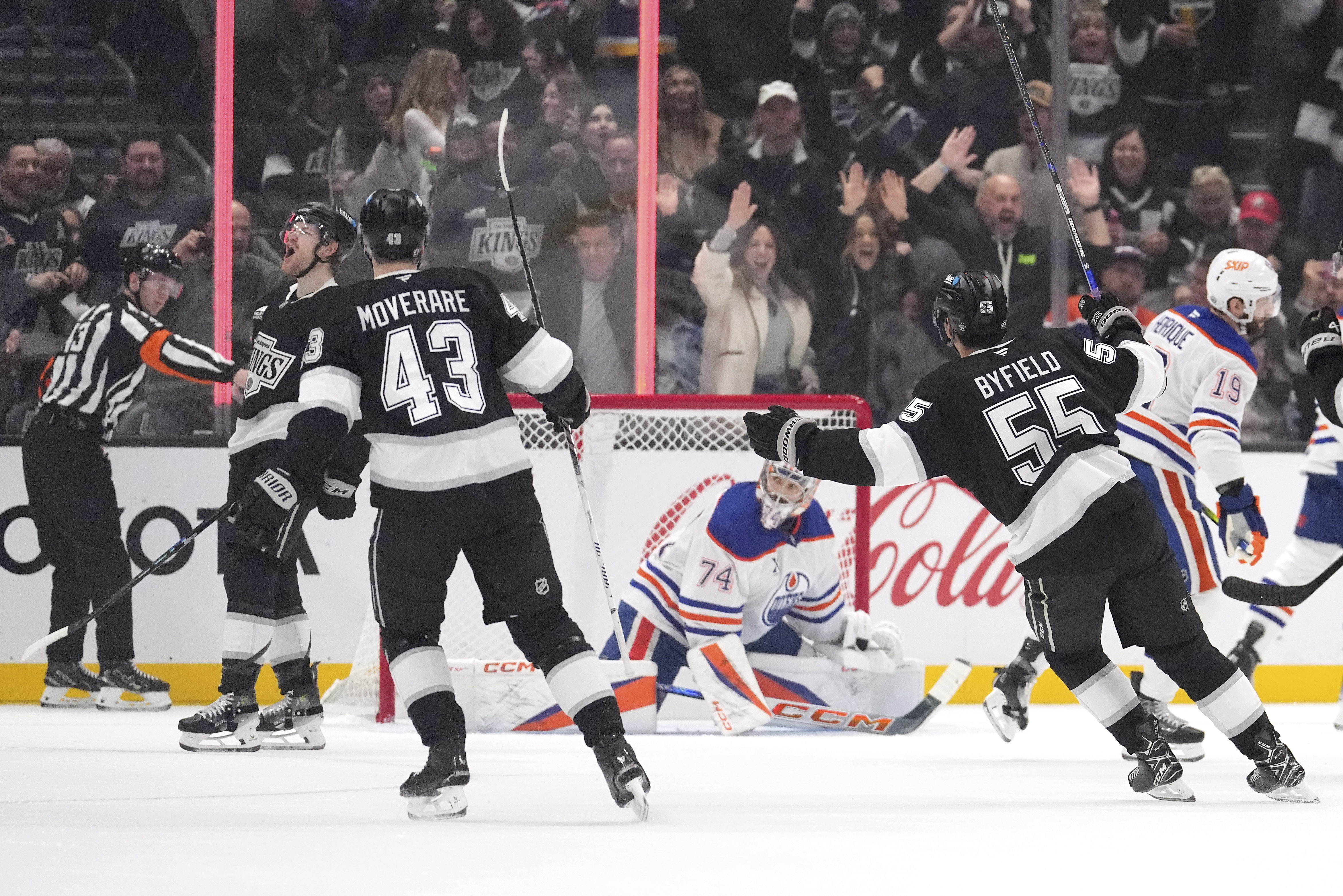Los Angeles Kings left wing Warren Foegele, second from left, celebrates his goal along with defenseman Jacob Moverare, third from left, and right wing Quinton Byfield, second from right, as Edmonton Oilers goaltender Stuart Skinner, center watches during the first period of an NHL hockey game, Saturday, Dec. 28, 2024, in Los Angeles. 