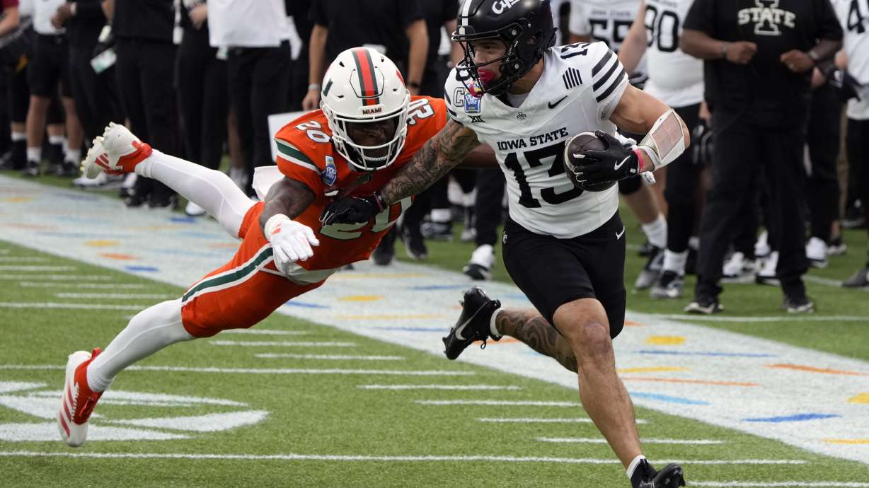 Iowa State wide receiver Jaylin Noel (13) runs after a reception before he is tackled by Miami defensive back Zaquan Patterson (20) during the first half of the Pop Tarts Bowl NCAA college football game, Saturday, Dec. 28, 2024, in Orlando, Fla.