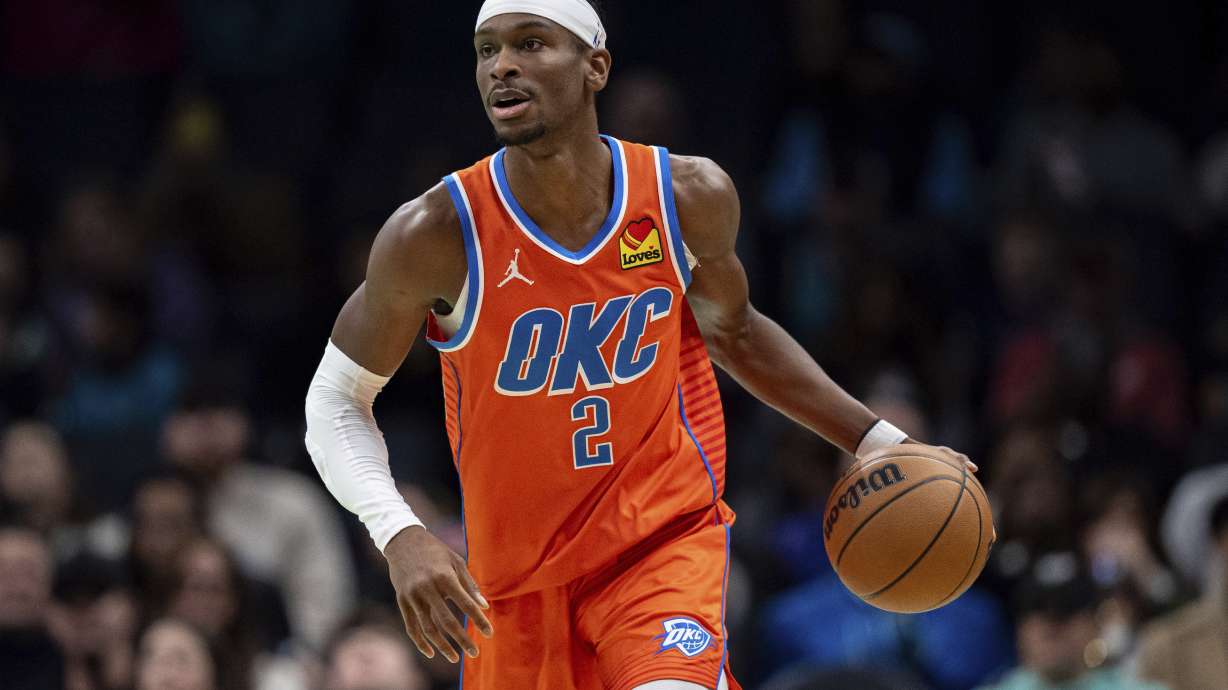 Oklahoma City Thunder guard Shai Gilgeous-Alexander (2) brings the ball up court during the first half of an NBA basketball game against the Charlotte Hornets in Charlotte, N.C., Saturday, Dec. 28, 2024.