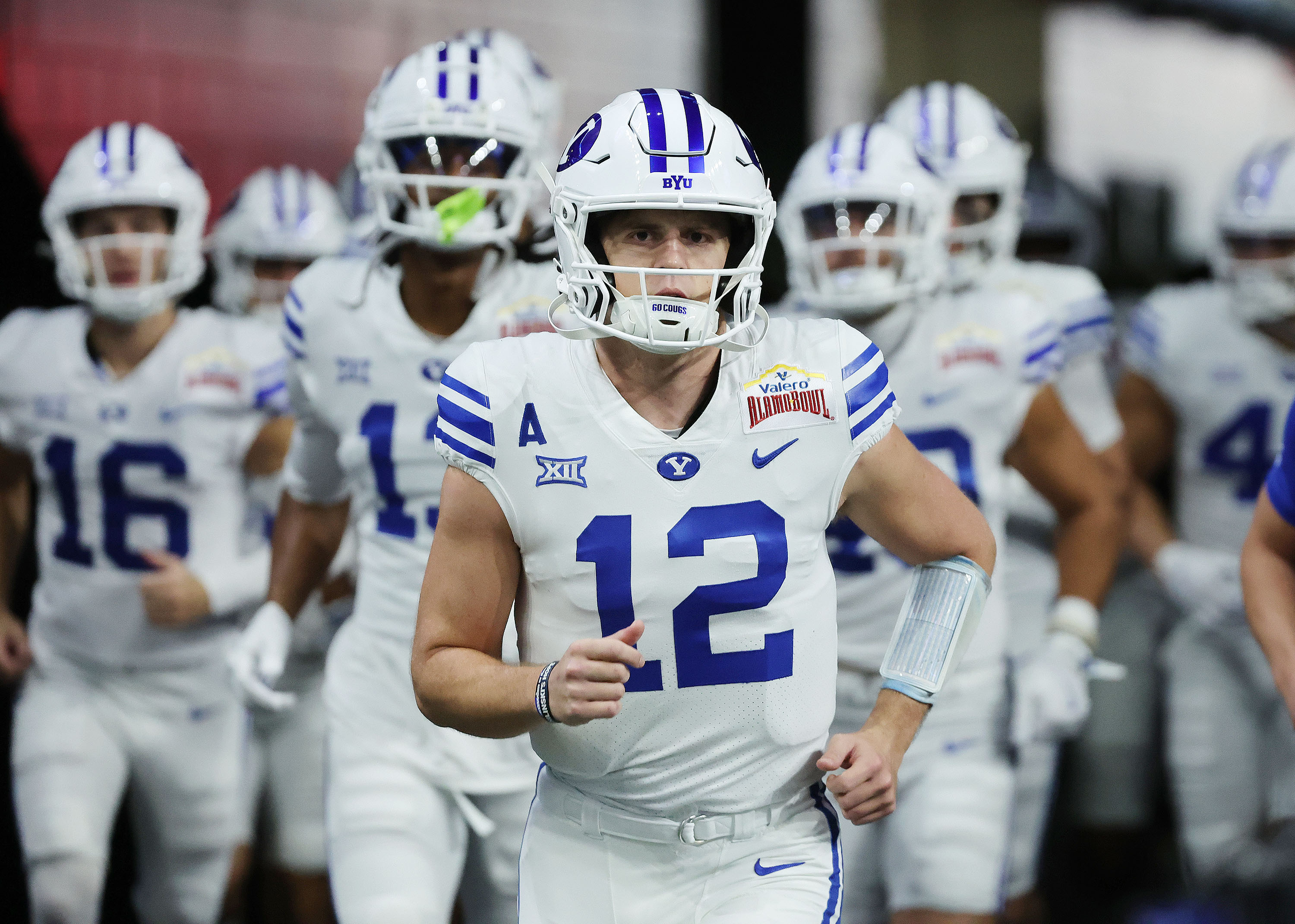 Brigham Young quarterback Jake Retzlaff (12) runs onto the field during warmups at the Valero Alamo Bowl in San Antonio on Saturday, Dec. 28, 2024.