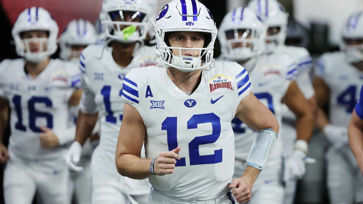 Brigham Young quarterback Jake Retzlaff (12) runs onto the field during warmups at the Valero Alamo Bowl in San Antonio on Saturday, Dec. 28, 2024.