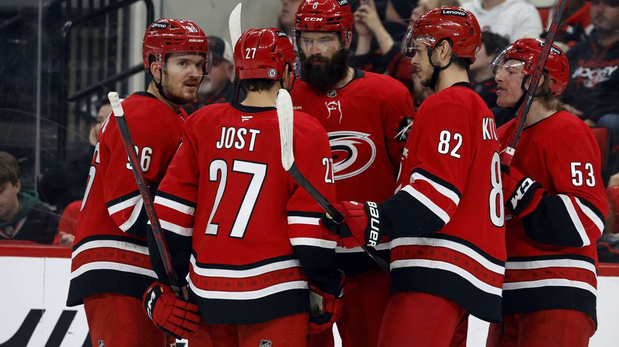 The Carolina Hurricanes huddle during a timeout during the second period of an NHL hockey game against the New Jersey Devils in Raleigh, N.C., Saturday, Dec. 28, 2024.
