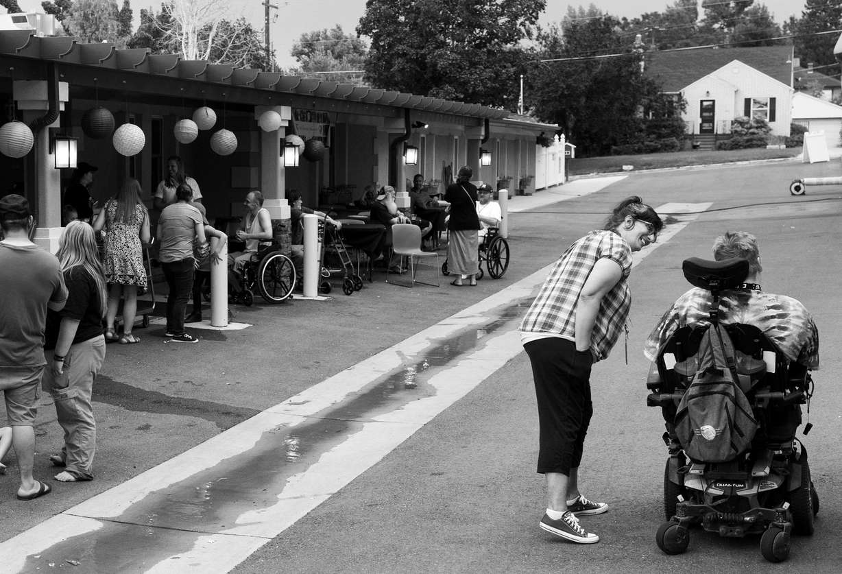 Kimberly Peterson chats with a resident during the eighth anniversary party at The INN Between in Salt Lake City on Aug. 17, 2023. Residents, their family members and neighbors were invited to the celebration.