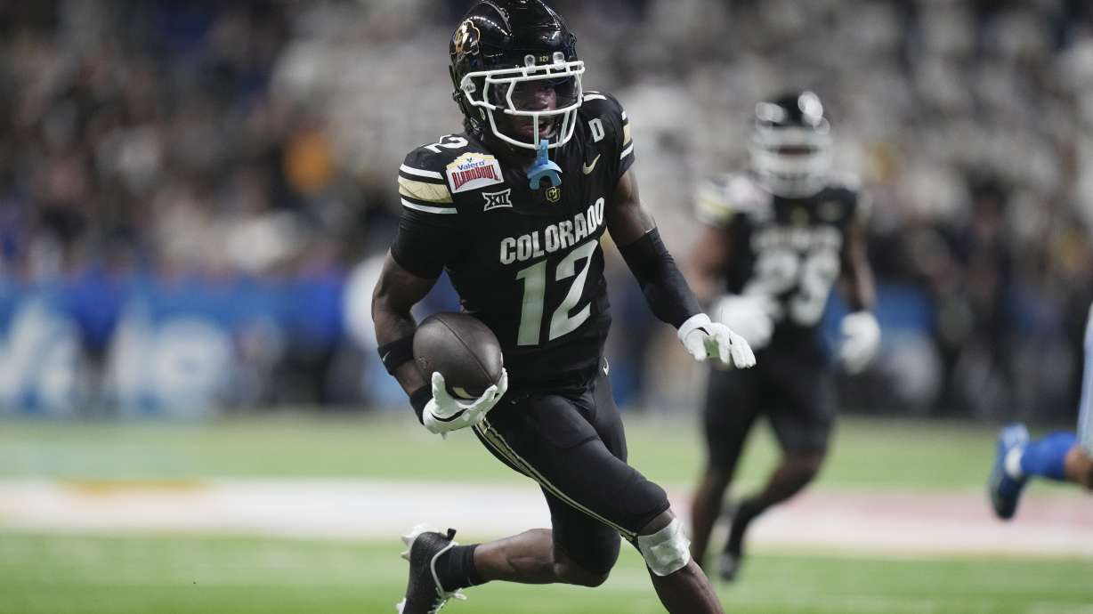 Colorado wide receiver Travis Hunter (12) runs for a touchdown against BYU after making a catch during the second half of the Alamo Bowl NCAA college football game, Saturday, Dec. 28, 2024, in San Antonio.