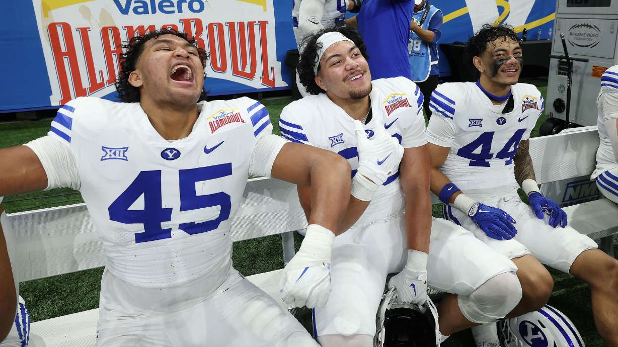 Brigham Young defensive end Viliami Po'uha (45), defensive end Sani Tuala (98) and defensive end Ephraim Asiata (44) celebrate their win during the Valero Alamo Bowl in San Antonio on Saturday, Dec. 28, 2024. BYU won 36-14.
