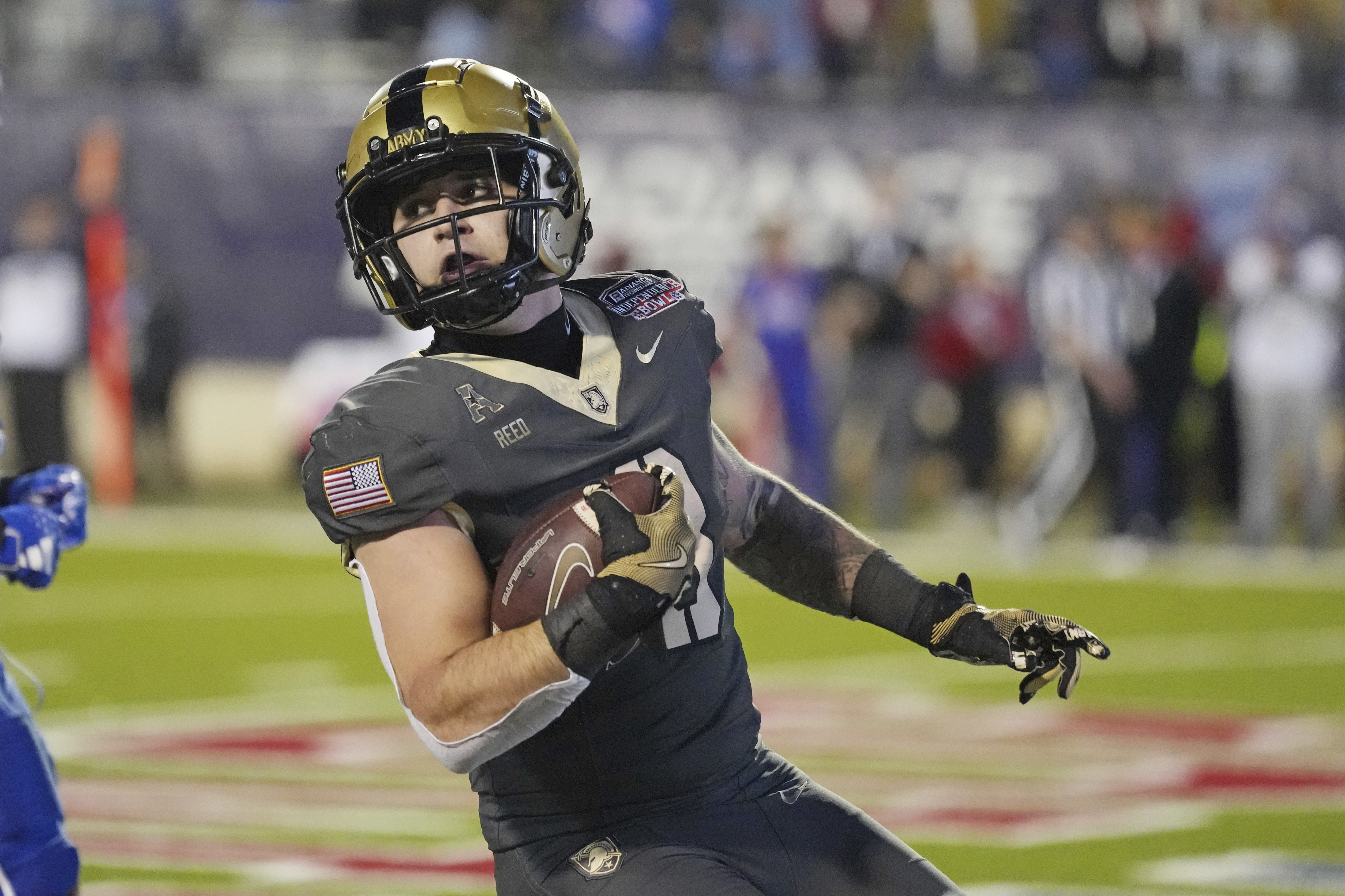 Army running back Hayden Reed looks back while on a touchdown run against Louisiana Tech during the first half of the Independence Bowl NCAA college football game, Saturday Dec. 28, 2024, in Shreveport, La.