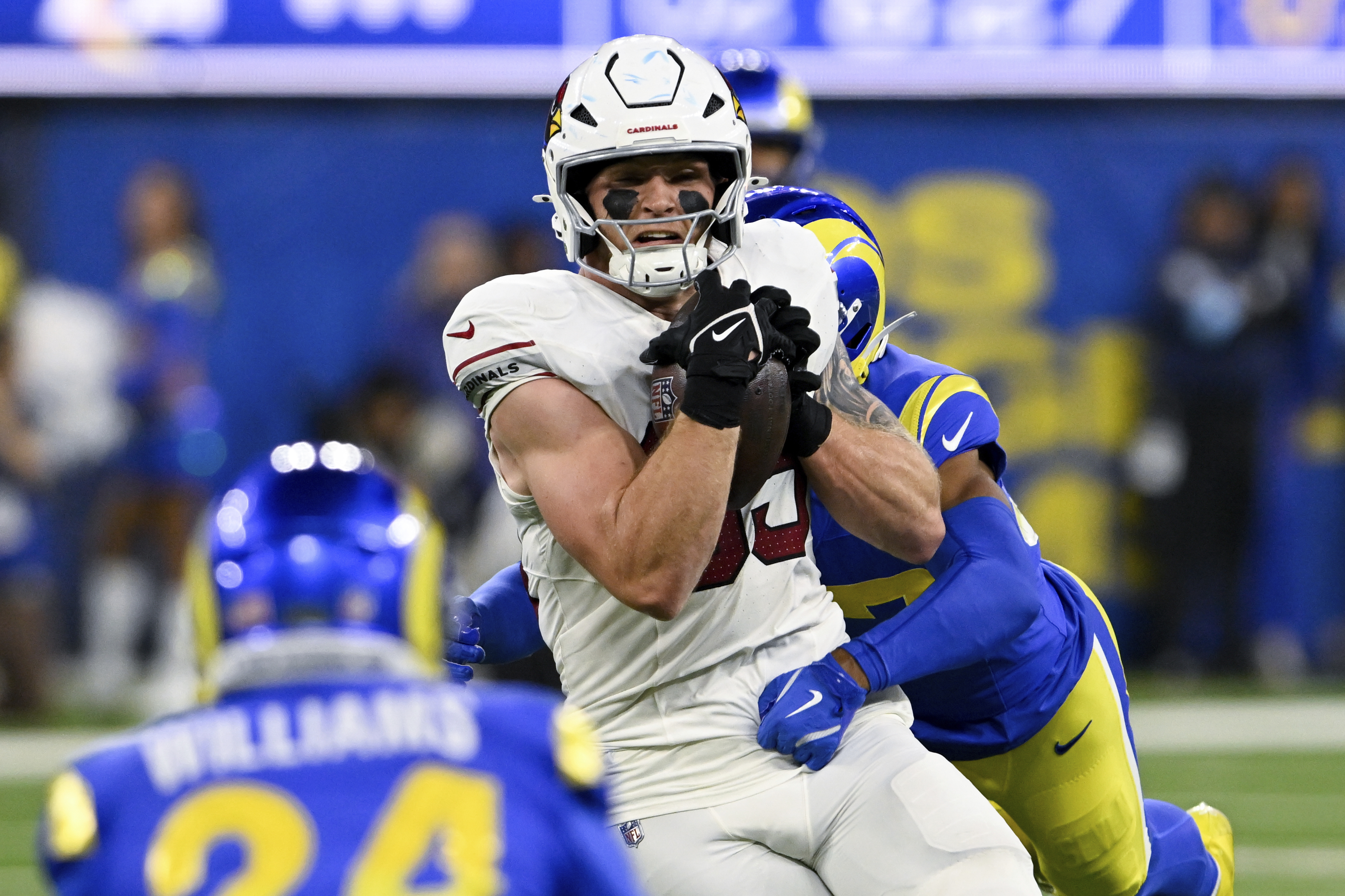Arizona Cardinals tight end Trey McBride (85) makes a catch while Los Angeles Rams safety Quentin Lake tackles him during the first half of an NFL football game Saturday, Dec. 28, 2024, in Inglewood, Calif. 