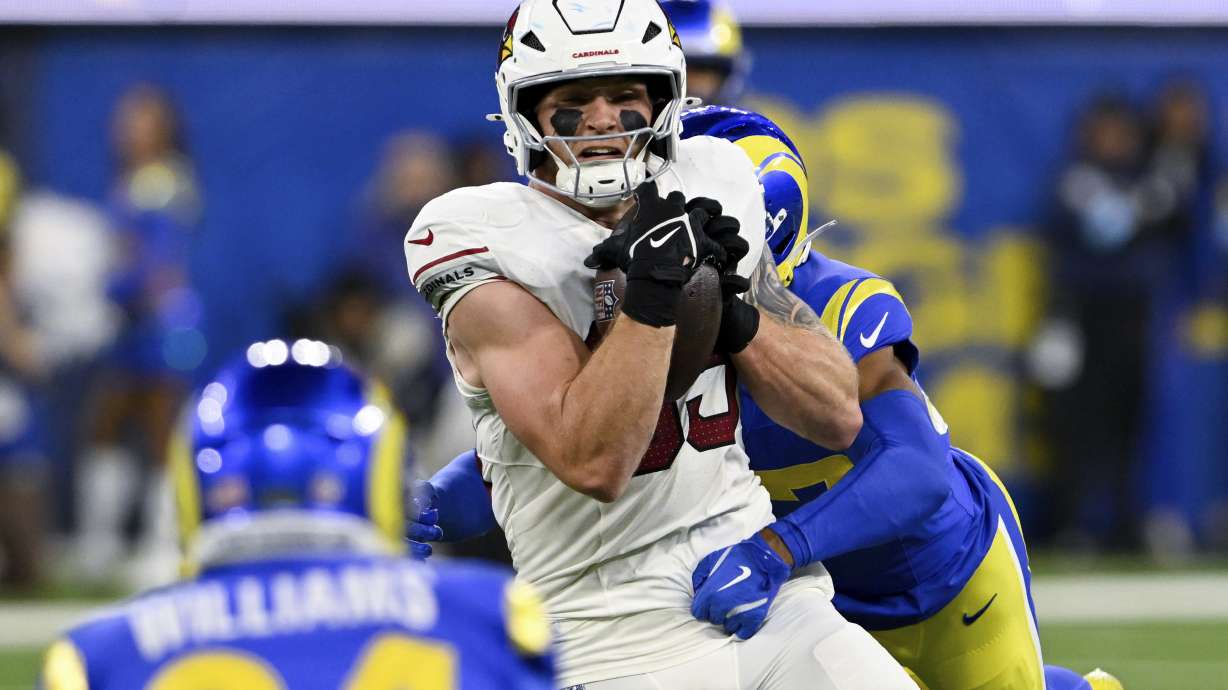Arizona Cardinals tight end Trey McBride (85) makes a catch while Los Angeles Rams safety Quentin Lake tackles him during the first half of an NFL football game Saturday, Dec. 28, 2024, in Inglewood, Calif.