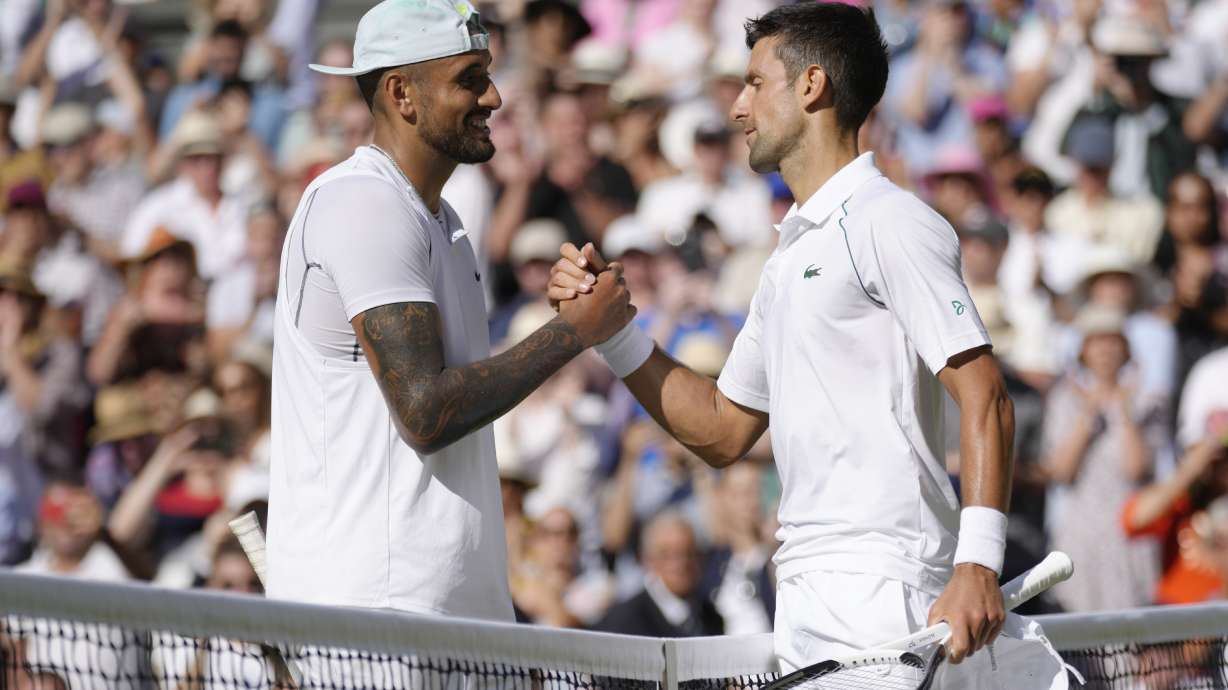 FILE - Serbia's Novak Djokovic, right, celebrates beating Australia's Nick Kyrgios in the final of the men's singles on day fourteen of the Wimbledon tennis championships in London, Sunday, July 10, 2022.