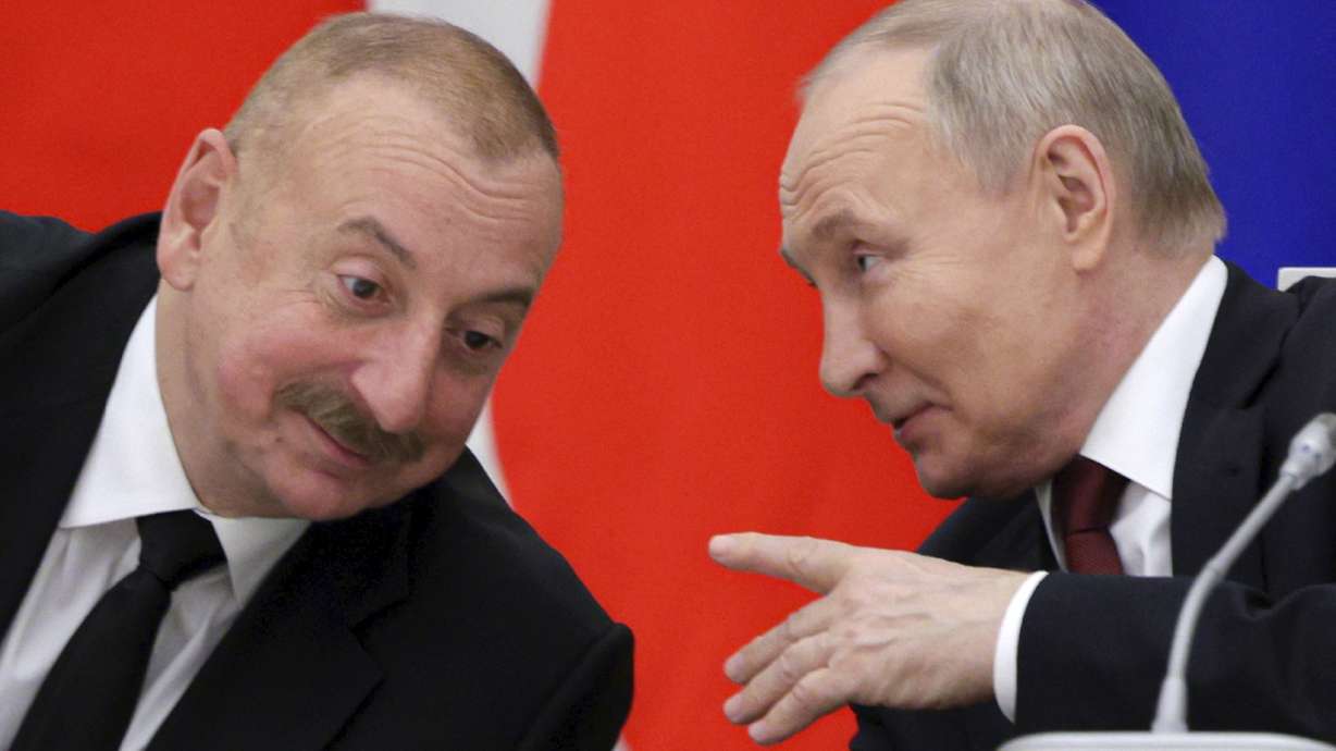Russian President Vladimir Putin, right, and Azerbaijani President Ilham Aliyev meet in Moscow, Russia, April 22. Aliyev said Sunday the Azerbaijani airliner that crashed last week was shot down by Russia, albeit unintentionally.