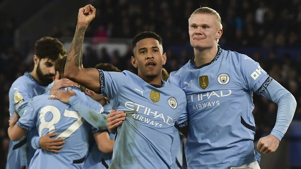 Manchester City's Erling Haaland, right, celebrates with Manchester City's Savinho after scoring his side's second goal during the English Premier League soccer match between Leicester City and Manchester City at King Power stadium in Leicester, England, Sunday, Dec. 29, 2024.